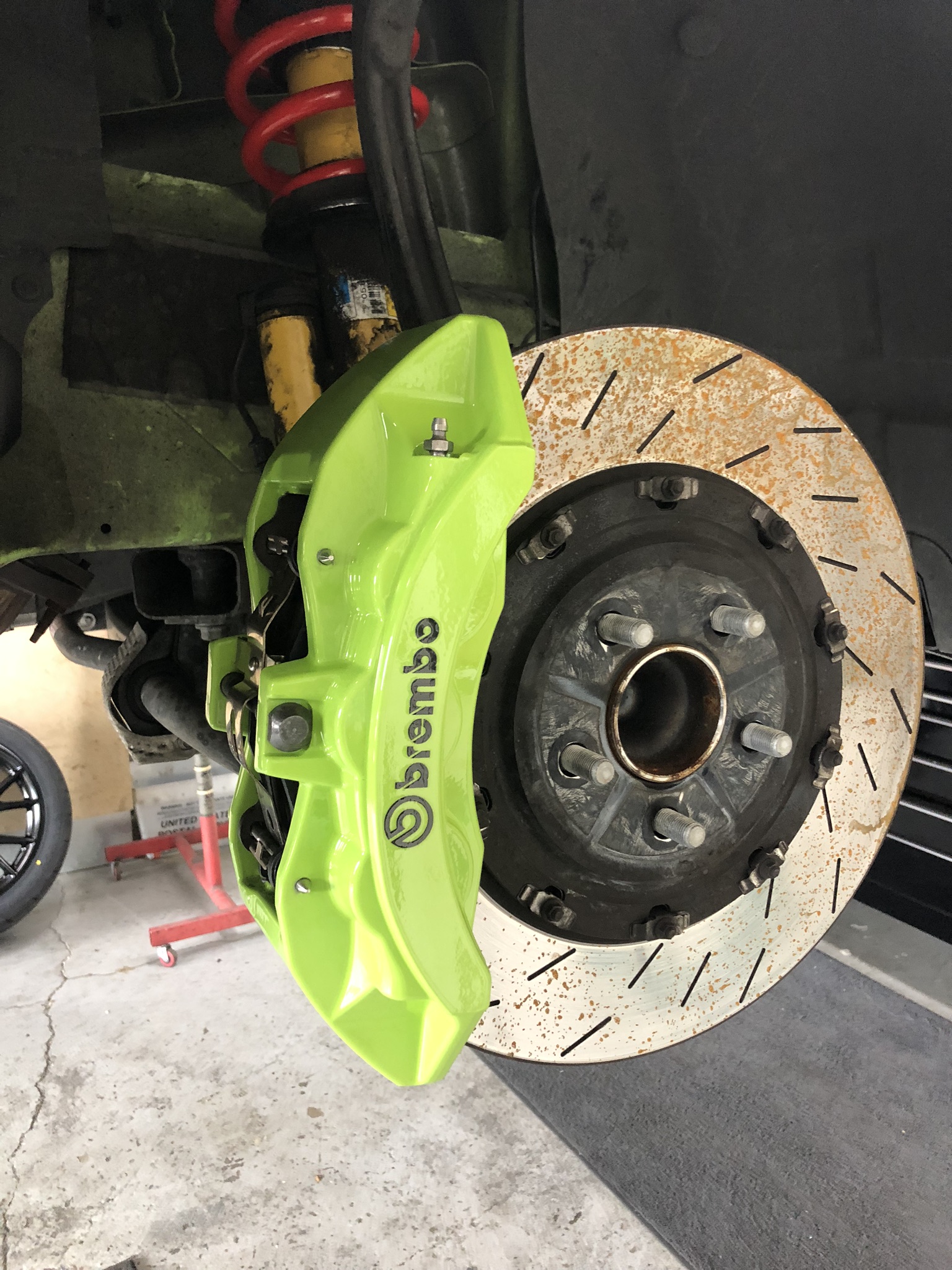 Neon green Brembo brake caliper on a Dodge Challenger (Sublime-style look)