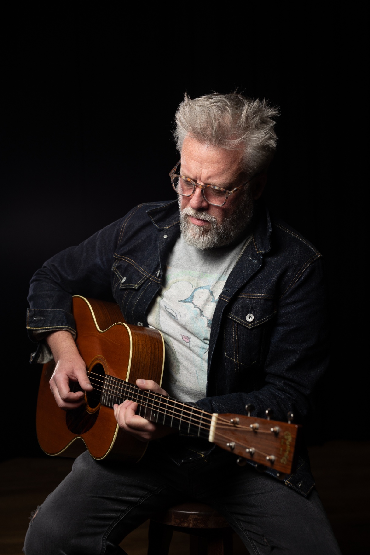 Damo performing acoustic guitar