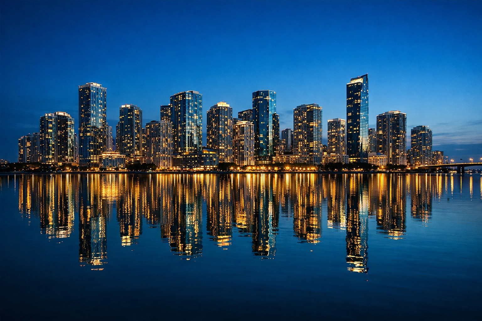 Fine art photography of the Miami Brickell skyline at night reflected in the calm water.