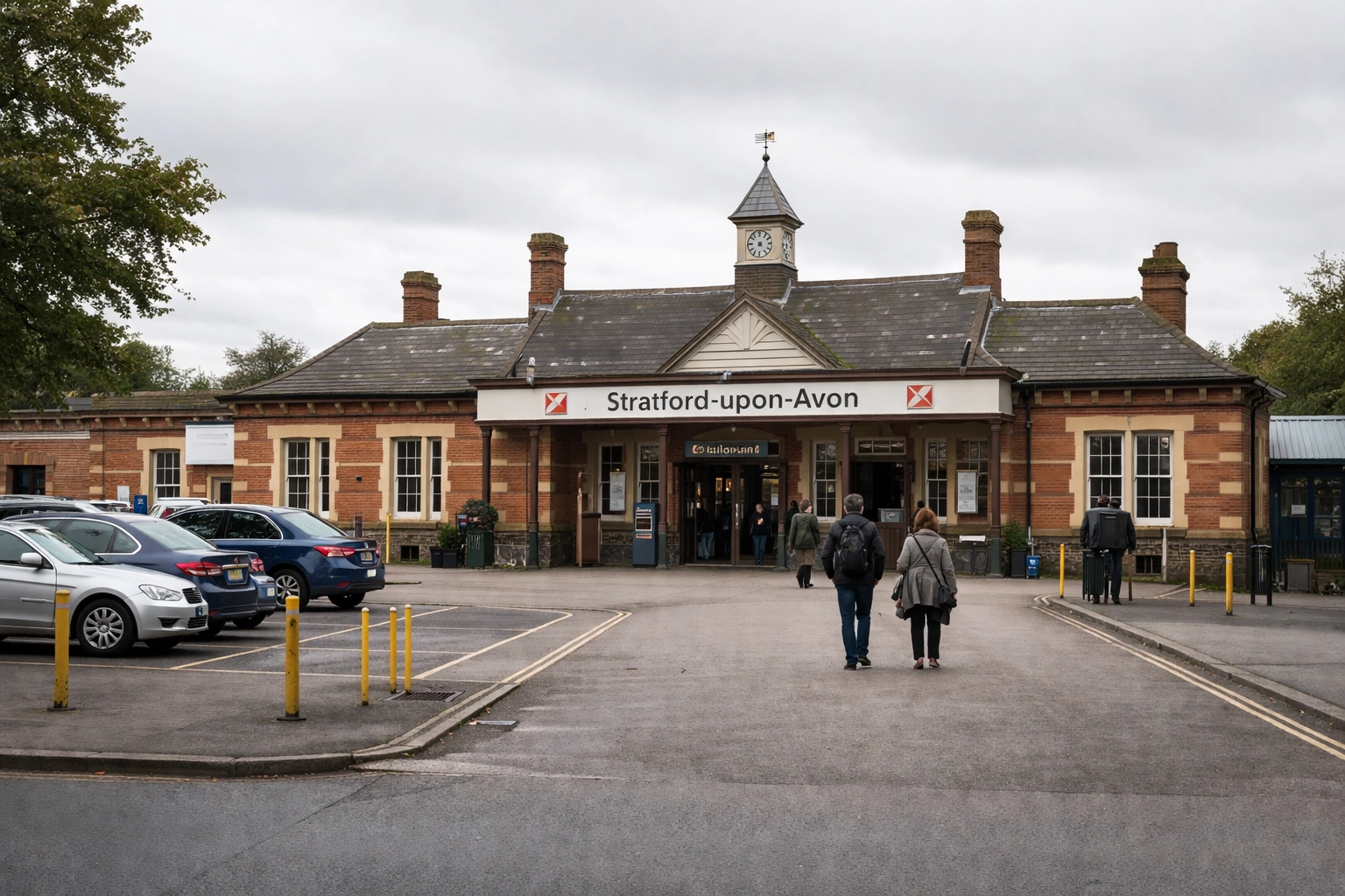 Stratford-upon-Avon railway station exterior with passengers exiting on an overcast day