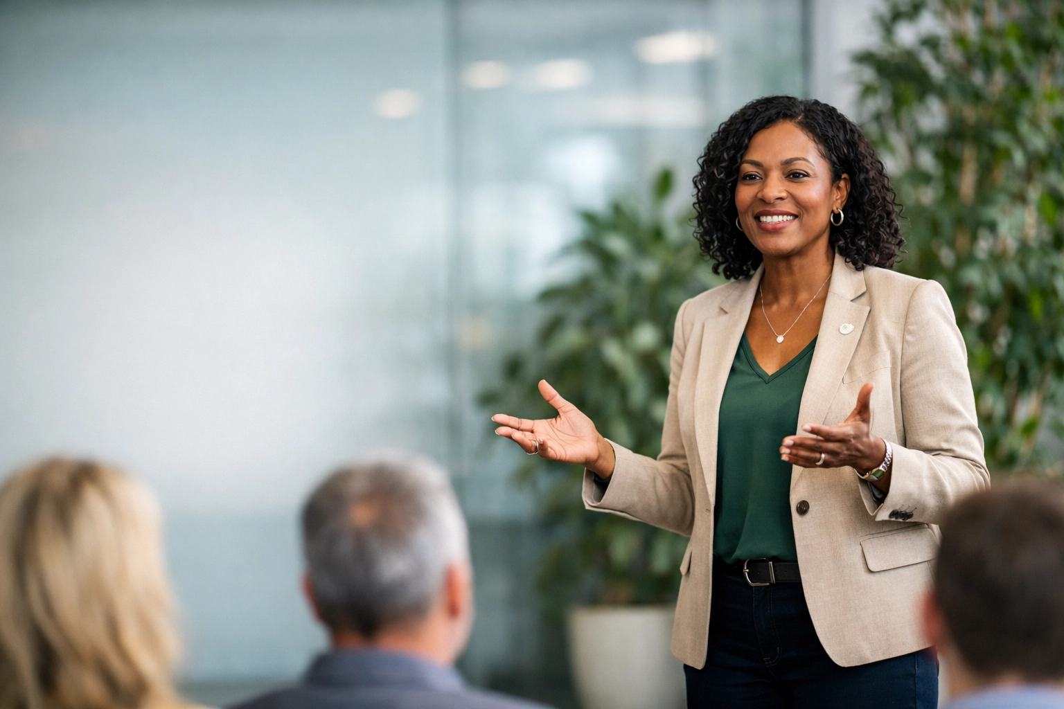 A female nonprofit leader presenting audit results and strategic financial plans to an engaged audience.