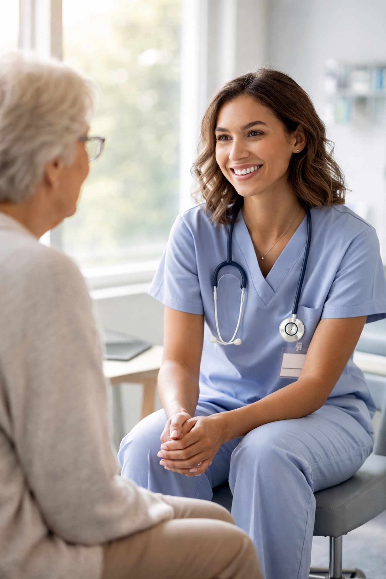 Nurse practitioner engaging with elderly patient thanks to AI documentation time savings