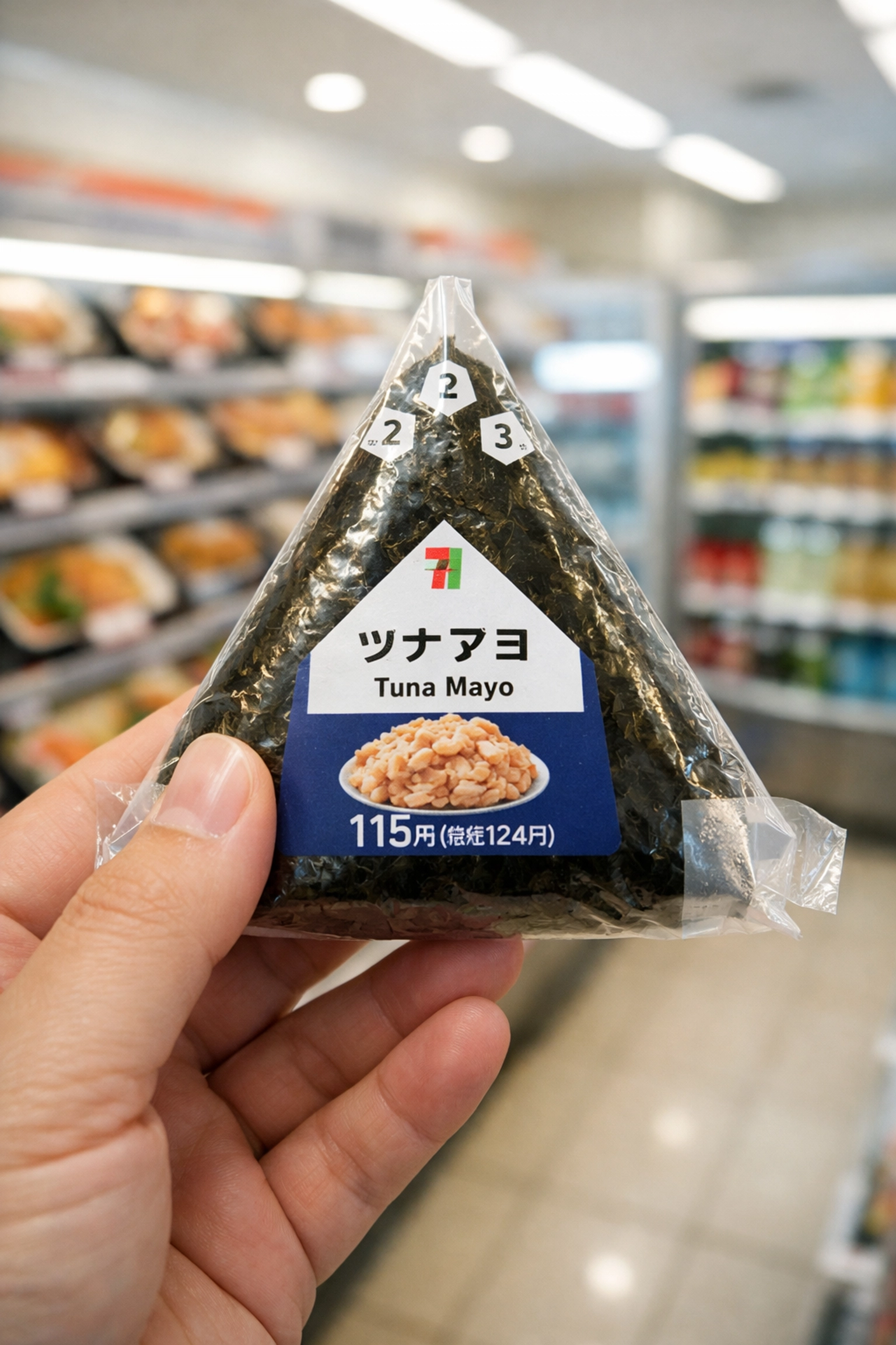 Fresh tuna mayo onigiri from a Tokyo convenience store, a top choice for budget travel food.