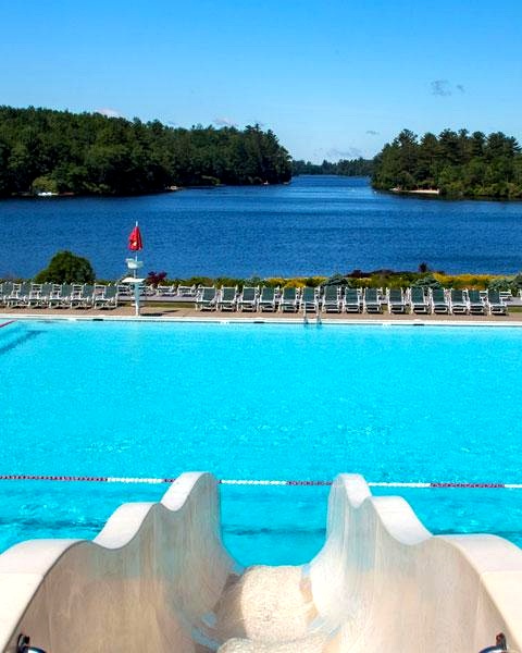 Large outdoor swimming pool with a water slide