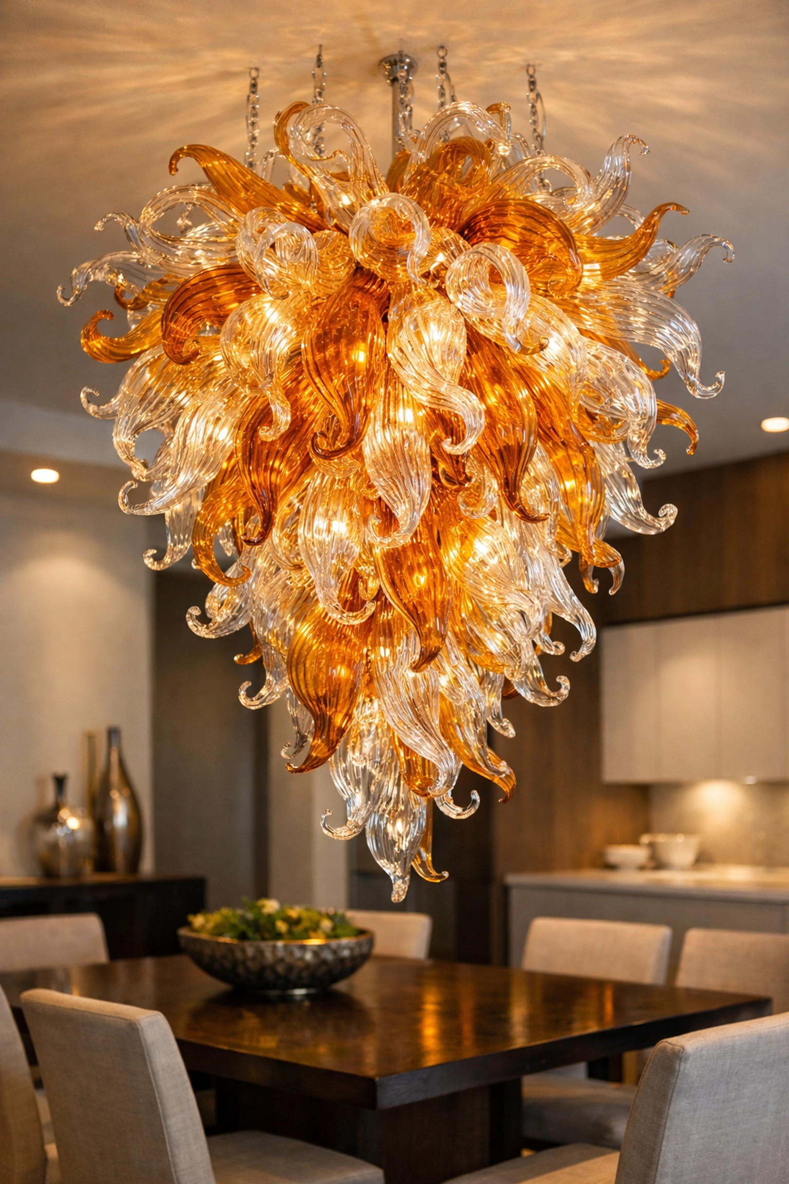Artistic hand-blown glass chandelier in a modern dining room showcasing professional cleaning of specialty fixtures.