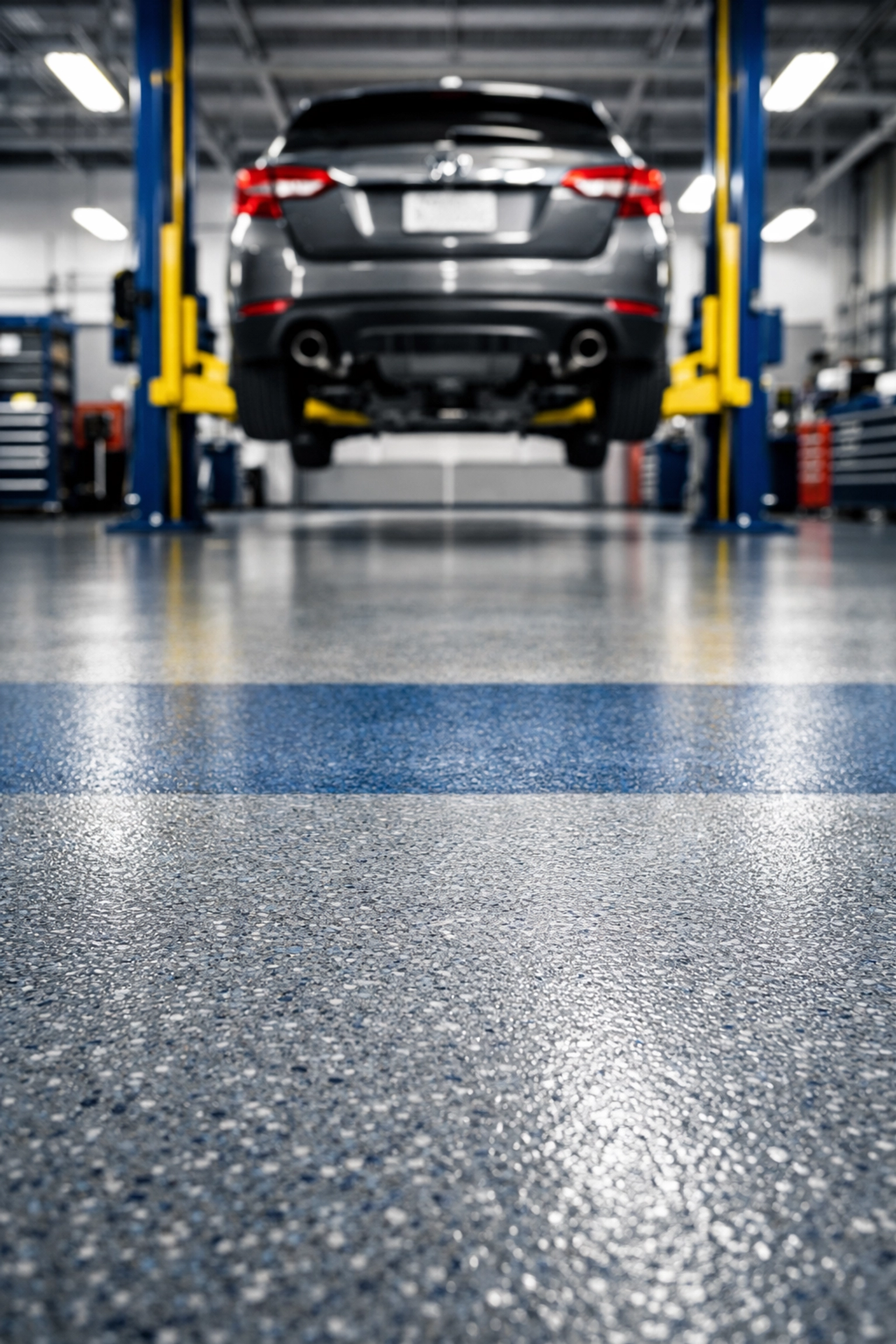 Professionally degreased garage floor in a Saugus auto repair shop featuring a clean service bay.