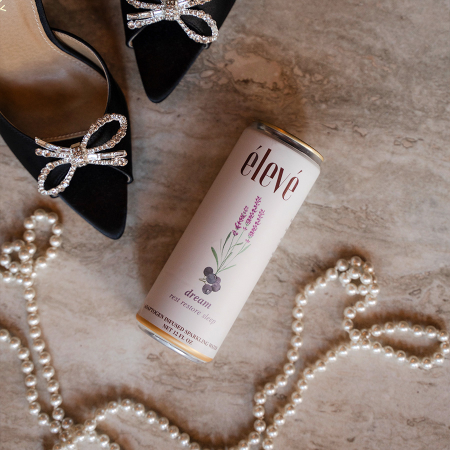 Dream can styled with black heels and pearls for a high-end fashion editorial vibe