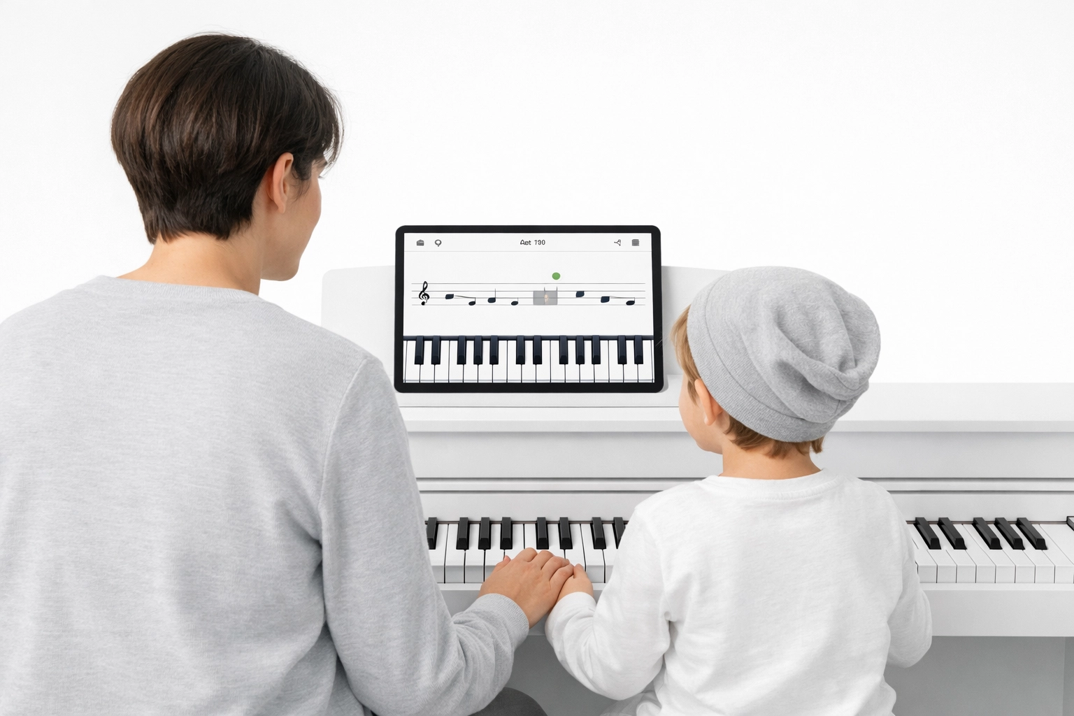 Parent and child practicing together using a tablet for fun online piano lessons at home.