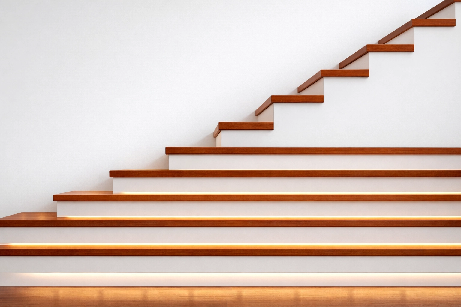 Modern staircase with high-contrast steps and LED baseboard lighting for fall prevention.