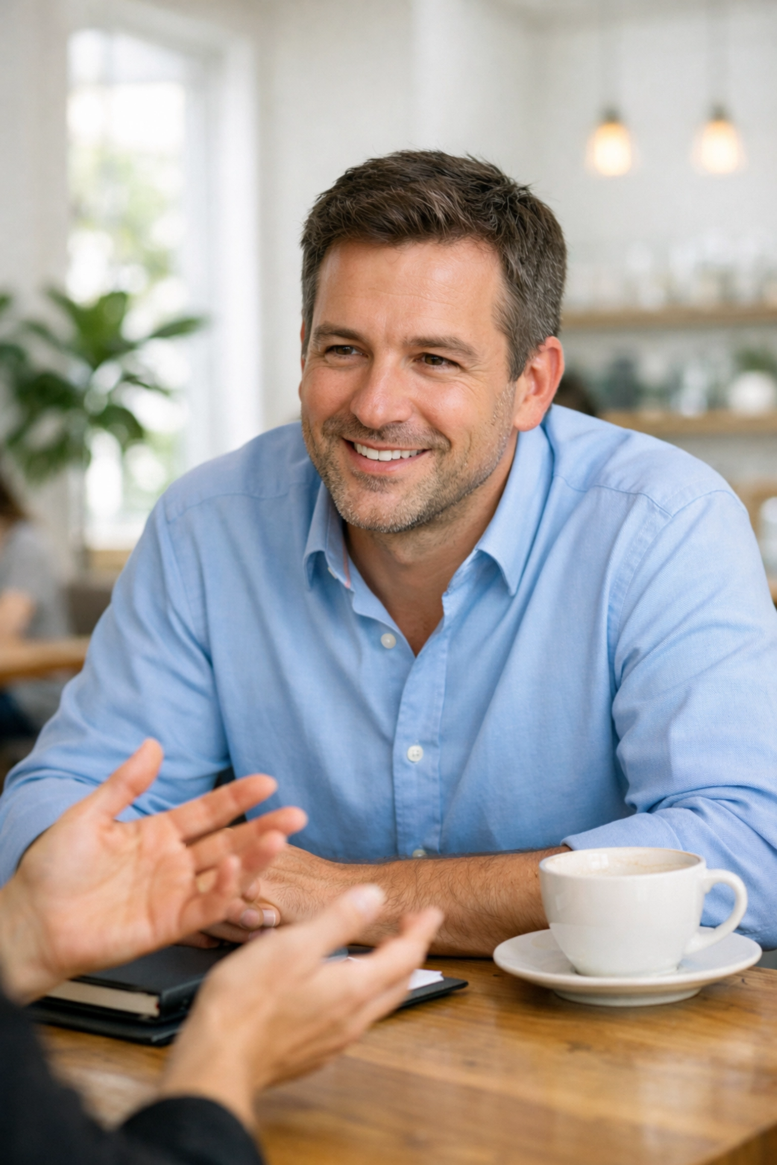 A professional fundraiser actively listening to a donor during a face-to-face cultivation meeting.