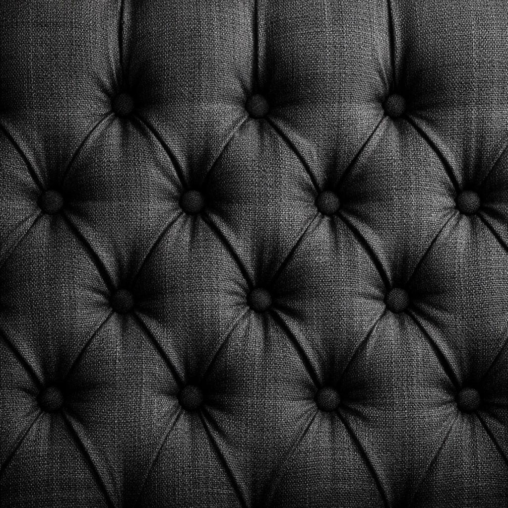 Close-up of a custom-tufted charcoal headboard showcasing premium craftsmanship and fabric texture.