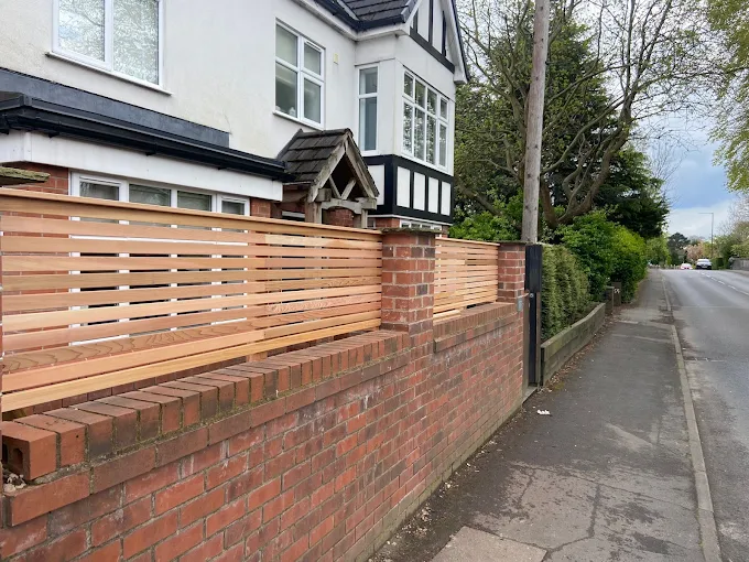 Modern Timber Slatted Fencing on Red Brick Wall
