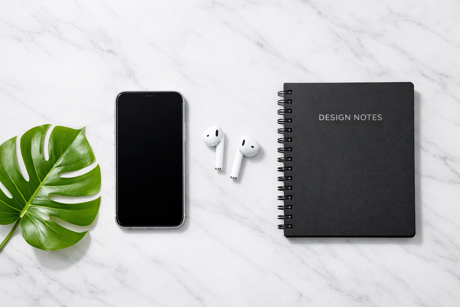 Smartphone and notebook depicting organized digital business listings and local SEO directory management.