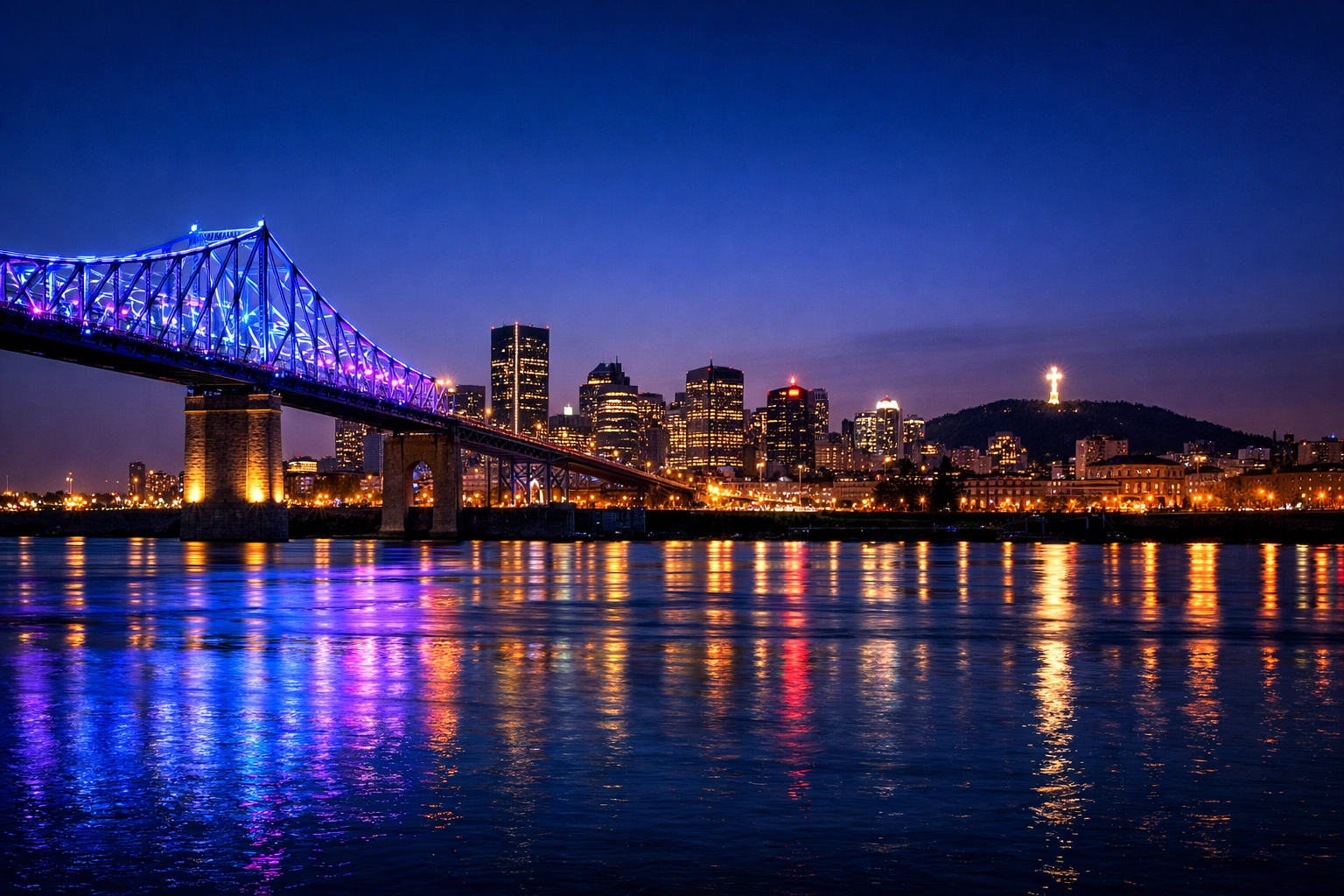 The glowing Jacques Cartier Bridge and Montreal city skyline at dusk from the Old Port.
