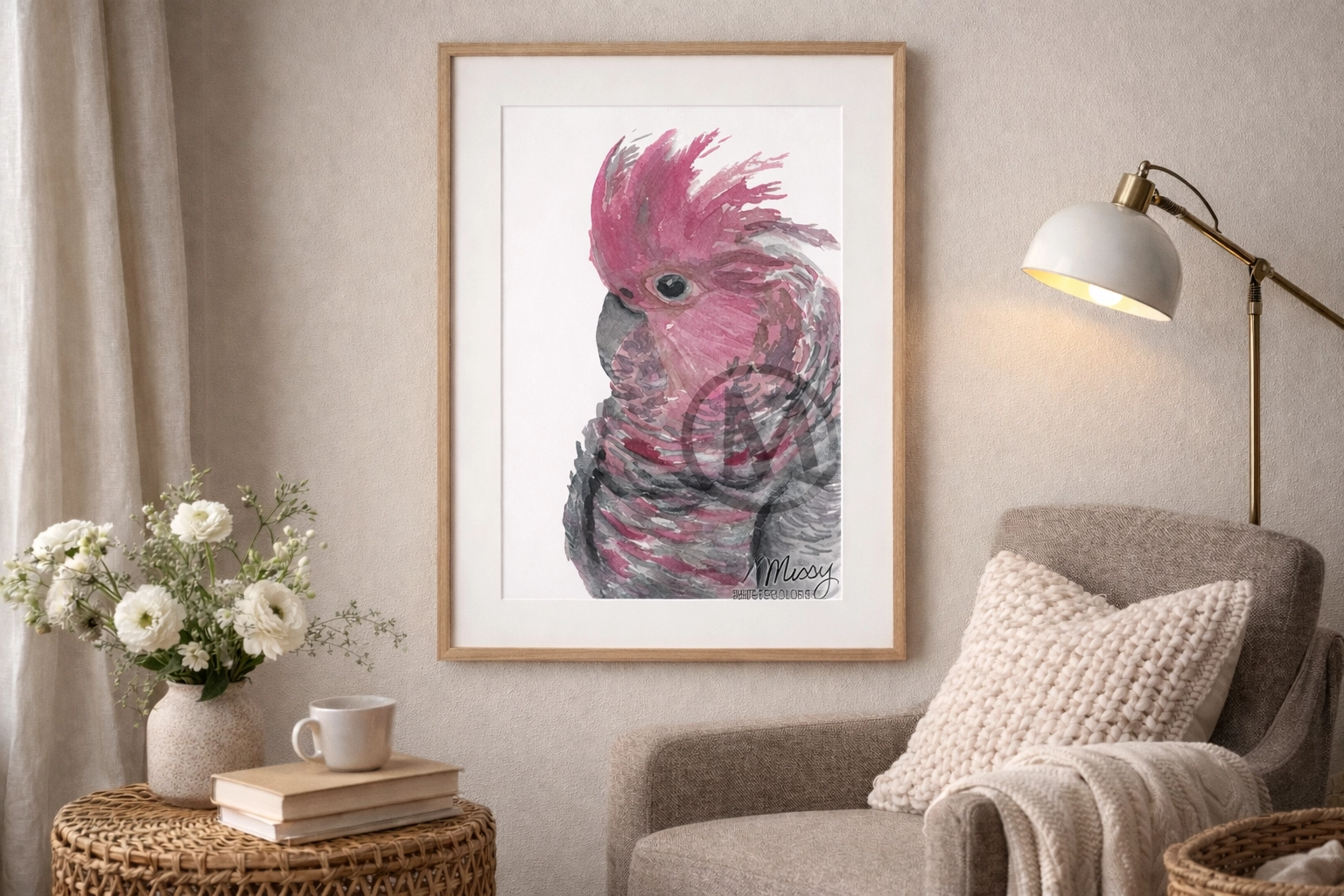 Pink Cockatoo watercolor print by Missy displayed in a cozy real-world reading nook mockup.