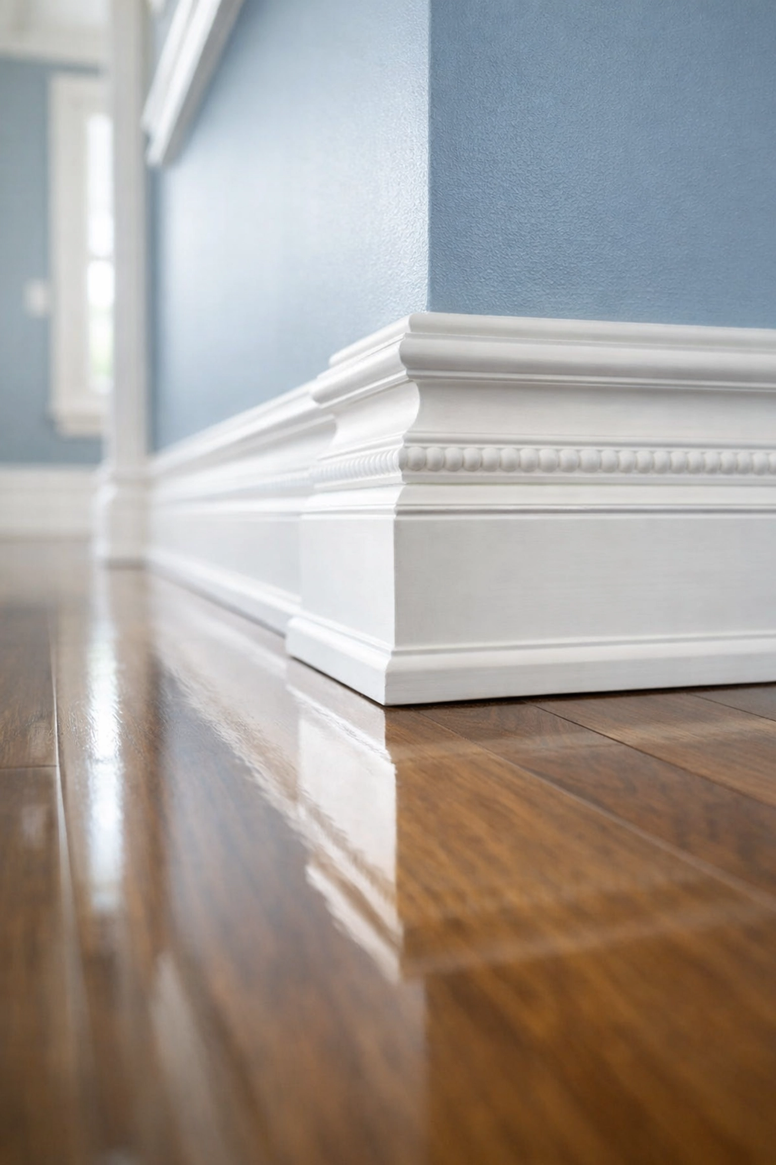 Deep move-in clean of white baseboards and polished hardwood floors in a professional Boston apartment service.