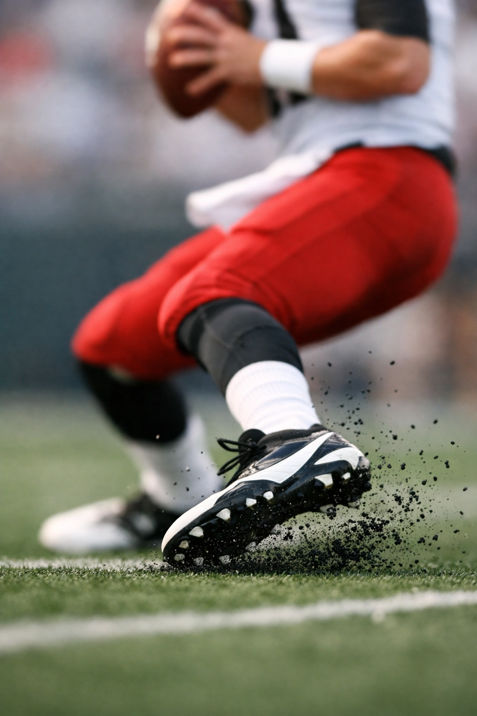 High-speed action shot of quarterback footwork and agility drills on synthetic turf.