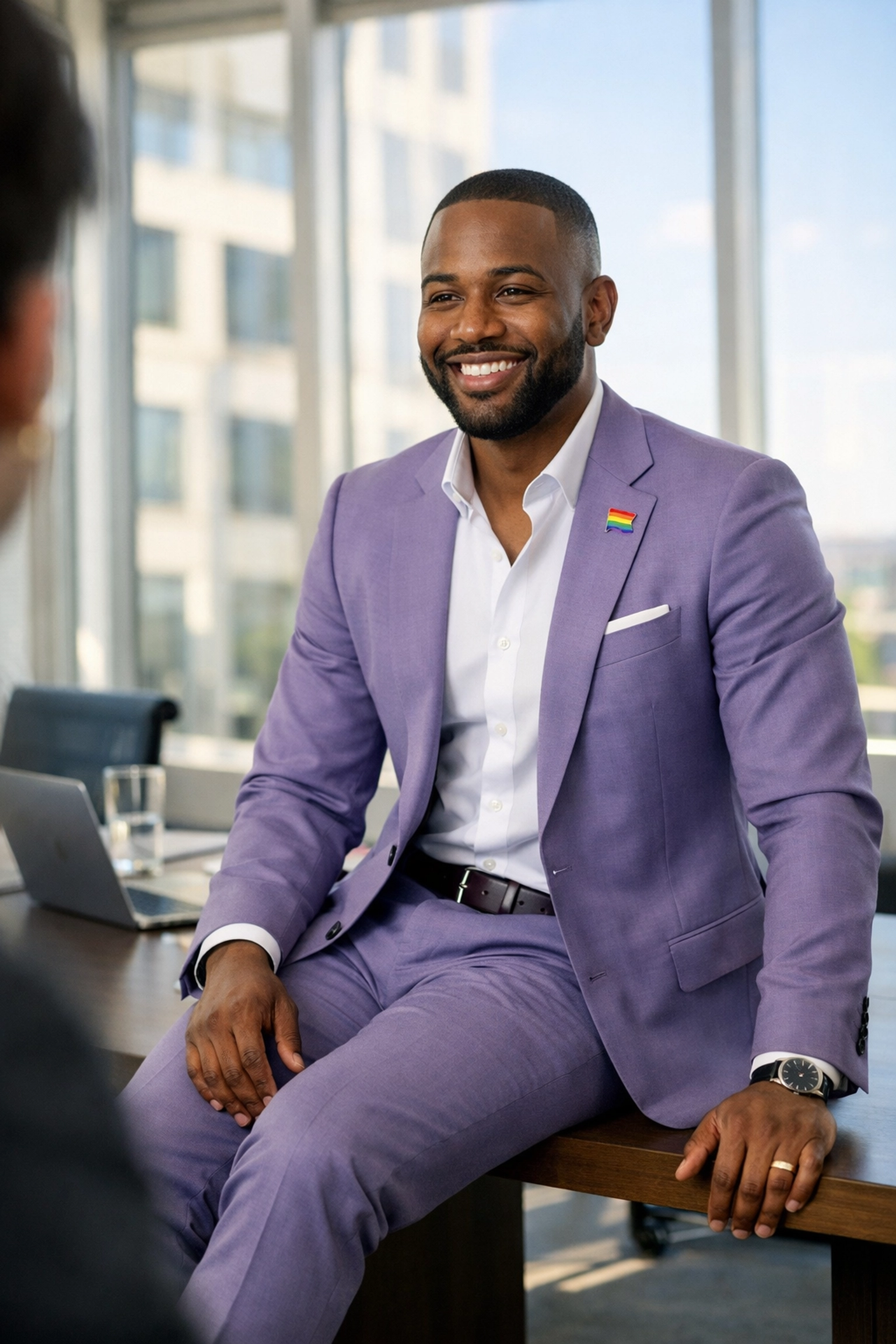 A confident Black gay man in a suit leading a meeting, representing queer leadership and professional growth.