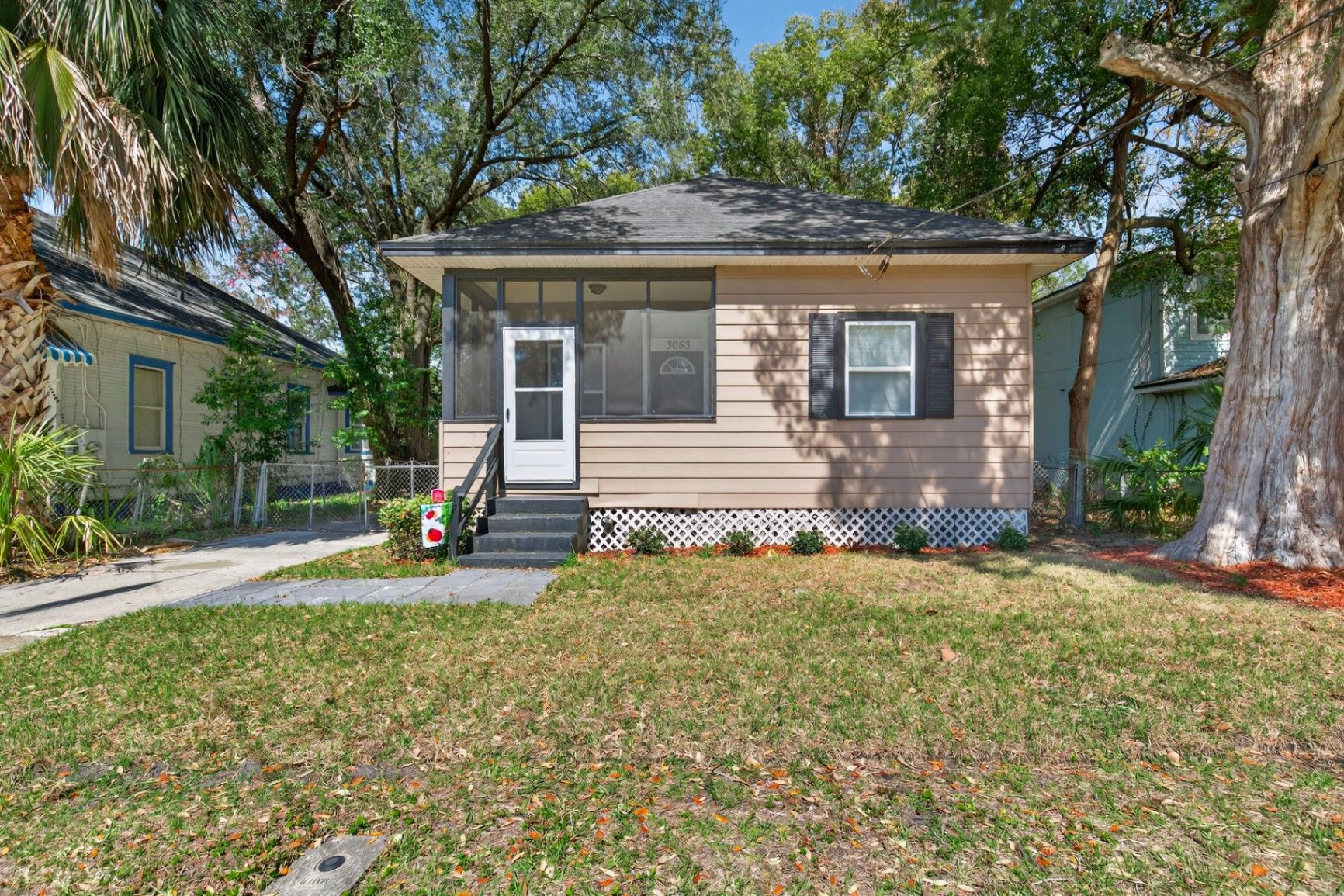 Before grass enhancement at 3053 Gilmore St showing patchy brown lawn