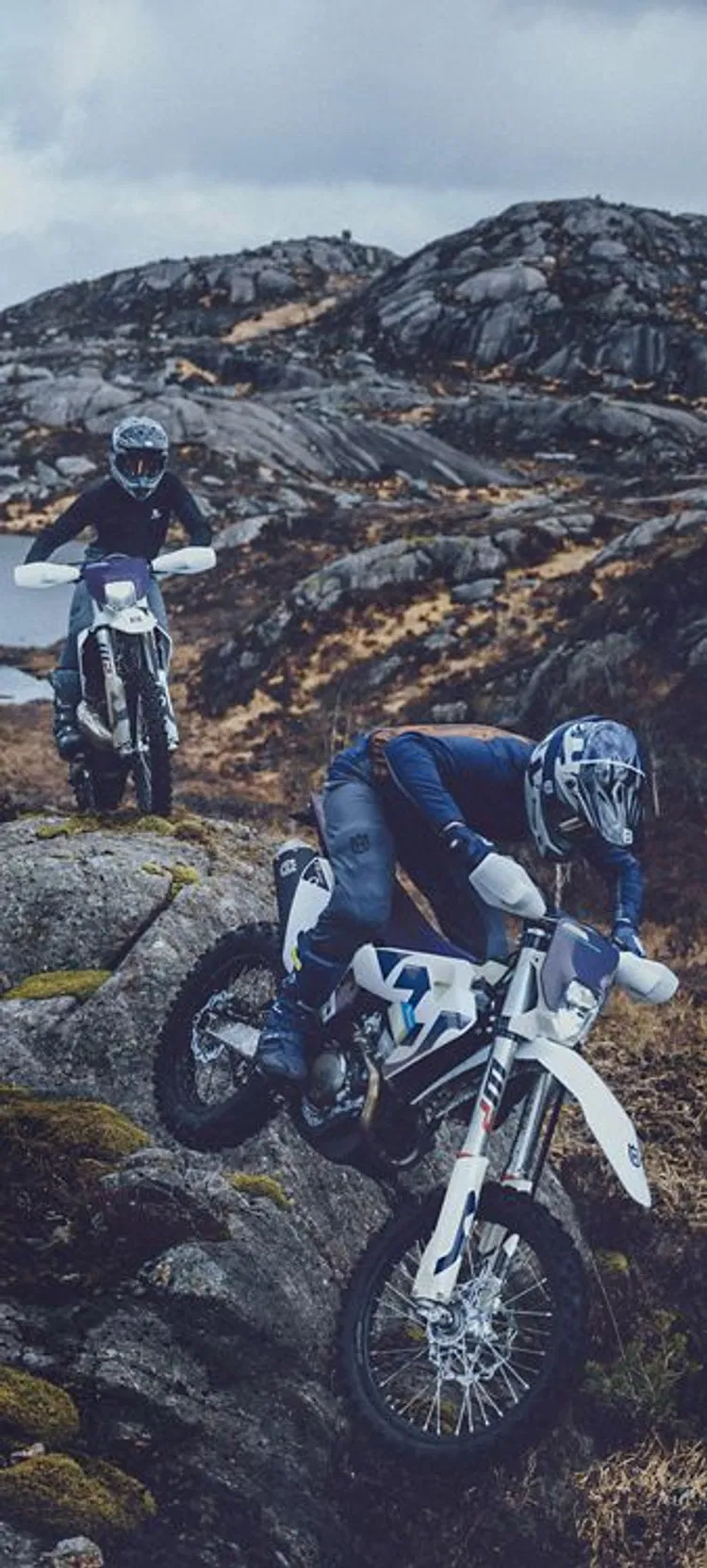 The Ultimate Guide to Off-Road Vehicles in Reno: Everything You Need for Tahoe Trails 2 Two riders on Husqvarna dirt bikes navigate steep rocky terrain, highlighting the durable build needed for Tahoe-area trails.