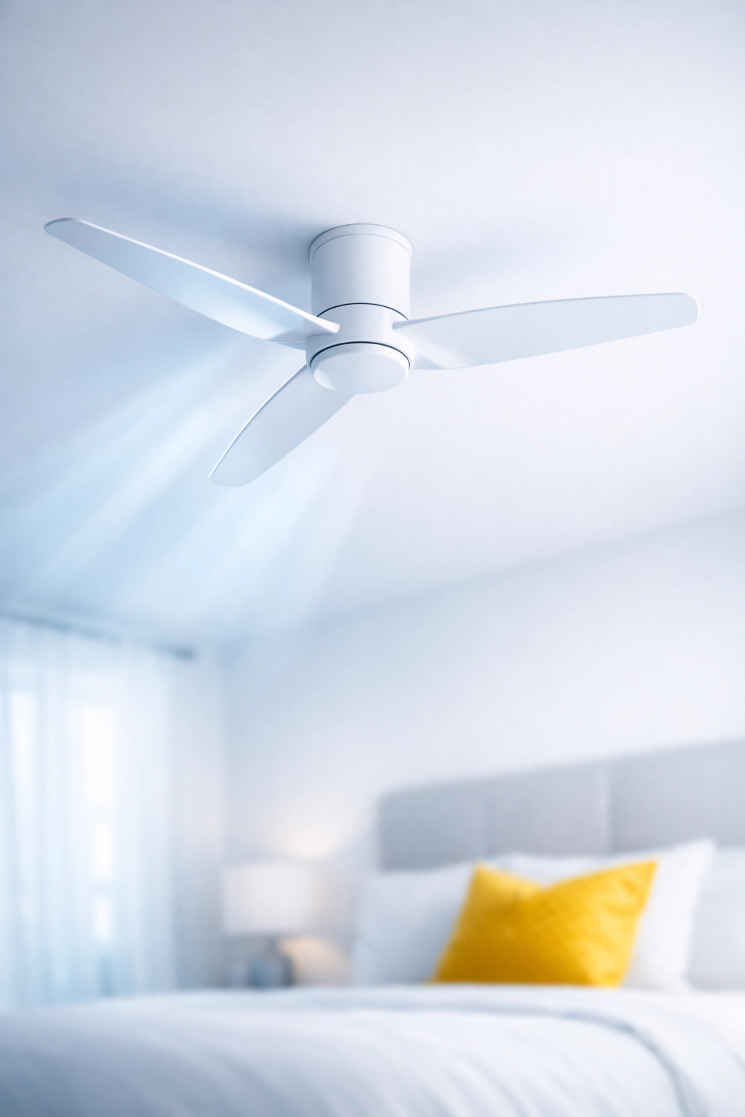 Clean white ceiling fan in a bright room representing improved indoor air quality and allergen removal.