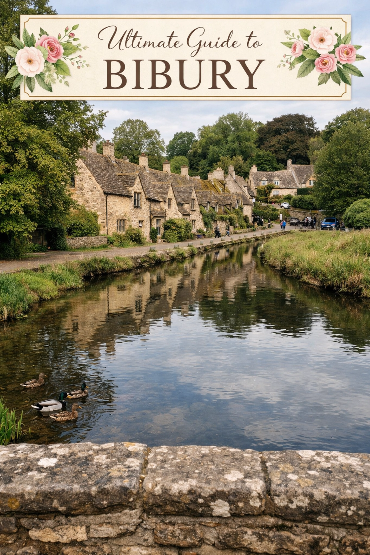 Scenic view from the Bibury stone bridge over the River Coln, showing historic Cotswold stone buildings and nature.