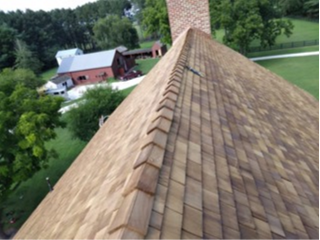 Newly installed cedar shingle roof showing ridge cap craftsmanship