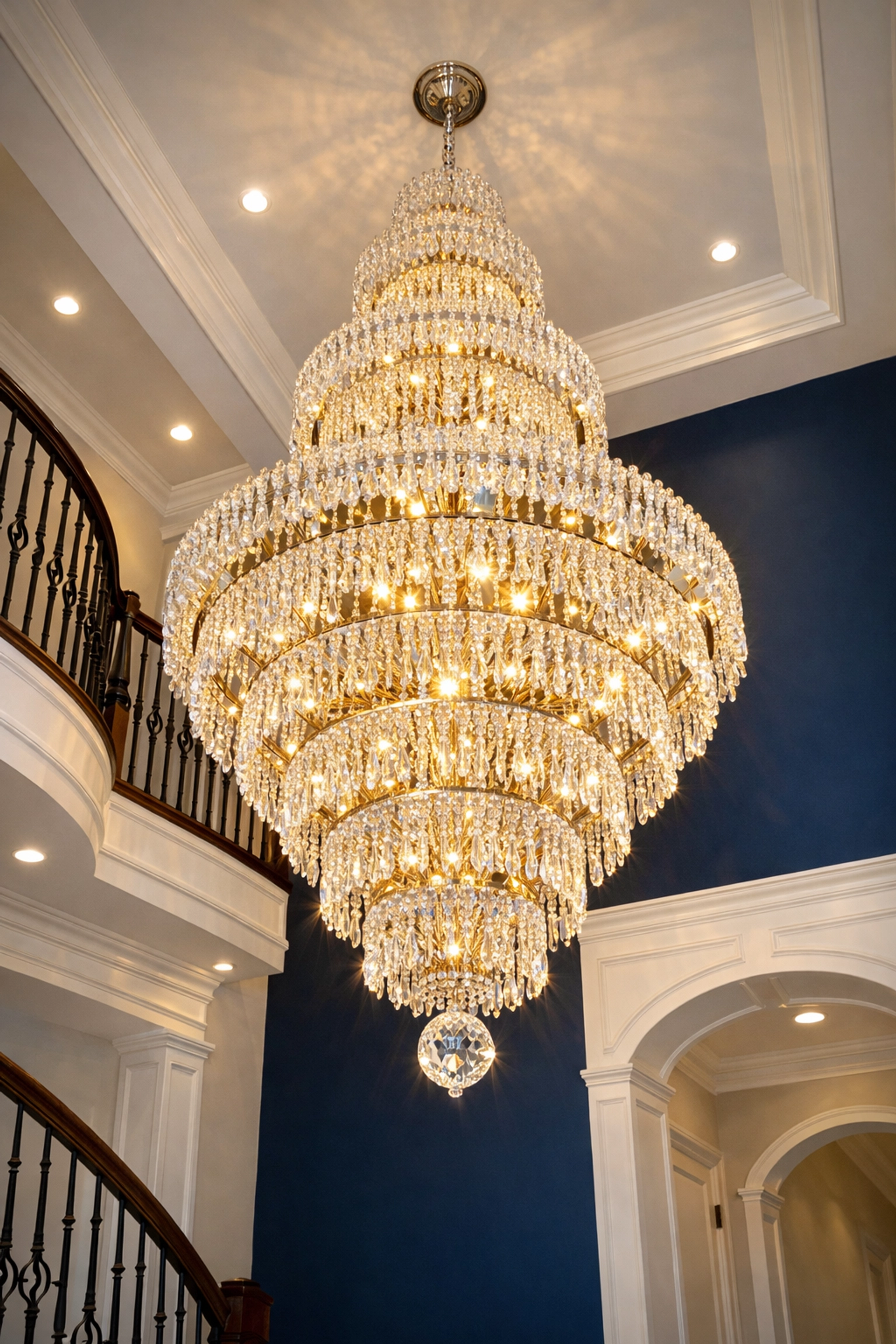 Sparkling crystal chandelier in a luxury foyer after professional post-construction cleaning.
