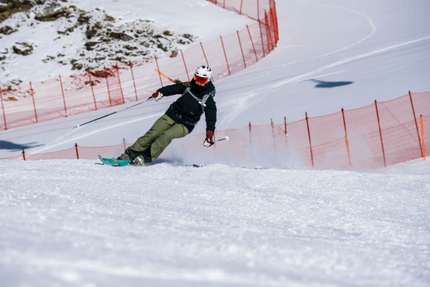 Skier in technical gear on a groomed slope