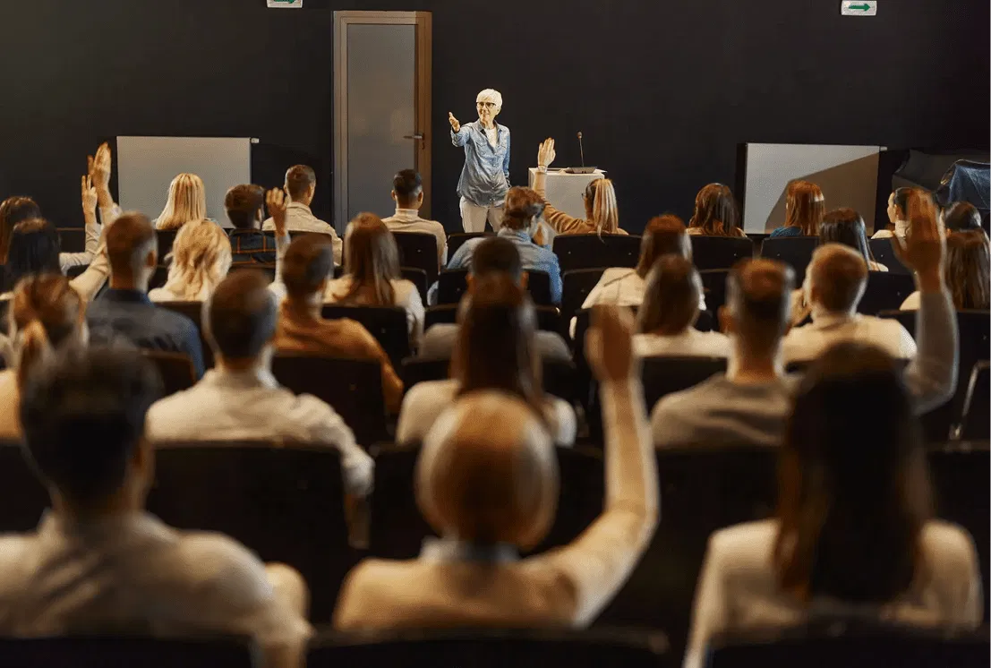 Trainer leading an interactive in-person seminar for automotive service professionals