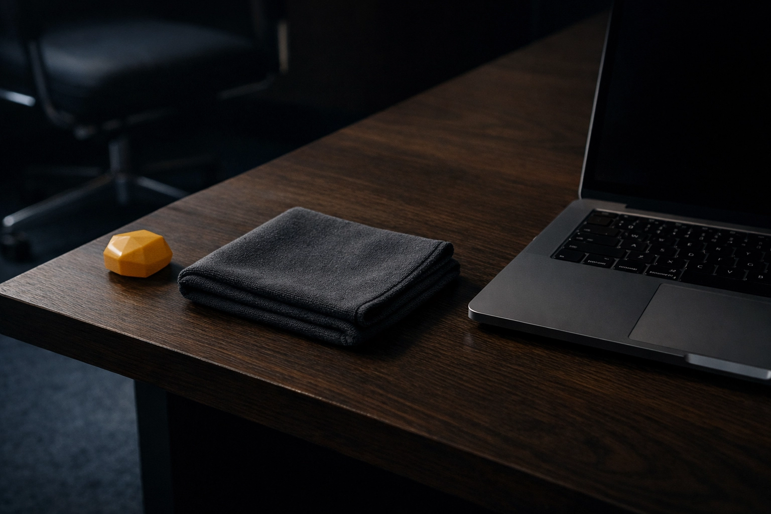 Minimalist office desk with a cleaning cloth, illustrating professional maintenance for a tidy and pest-free workspace.