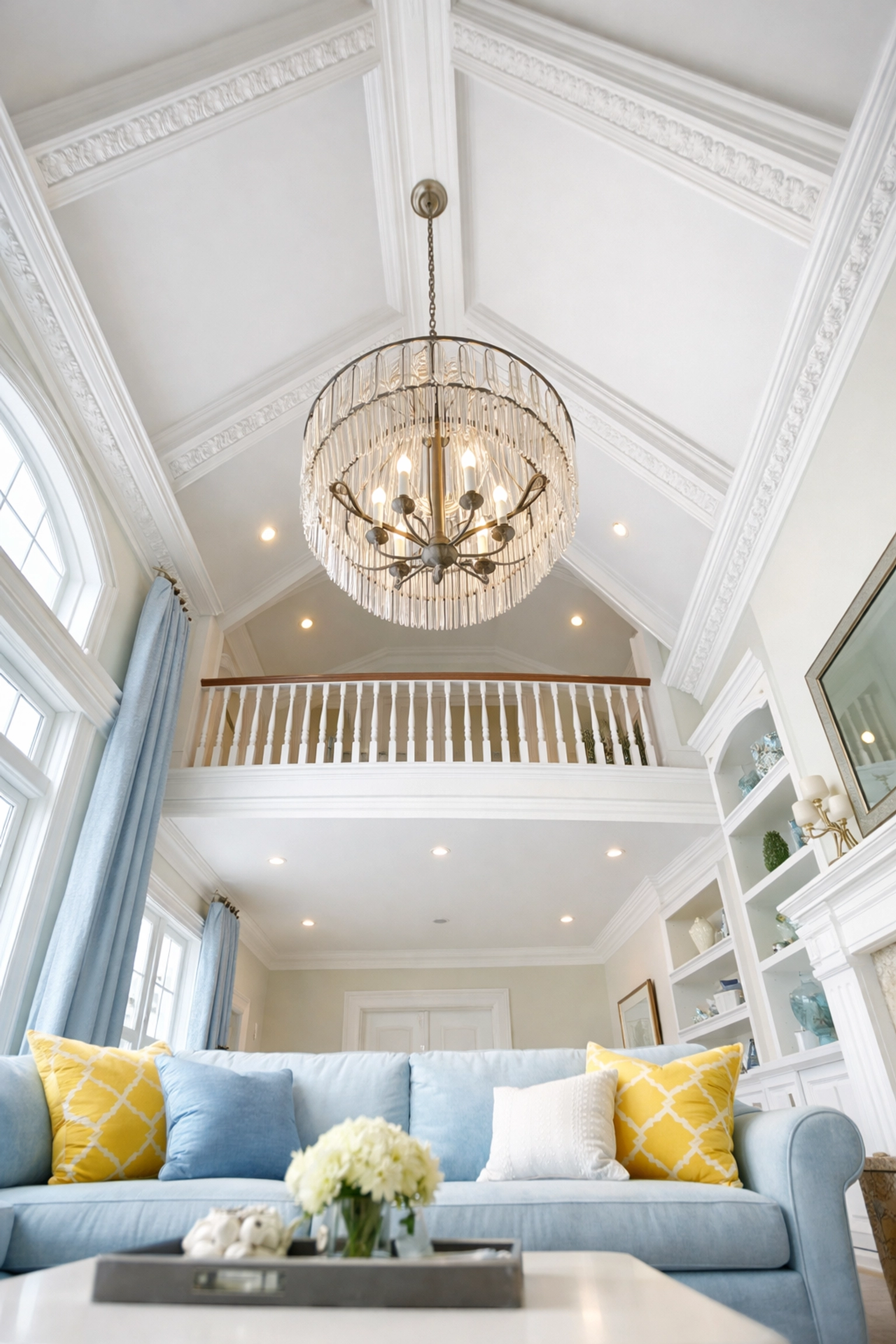 Dusting high-reach crown molding and ceiling fixtures in a renovated Bolton home living room.