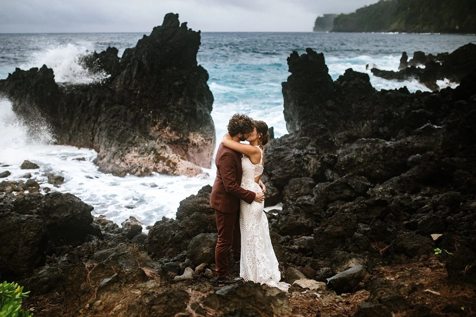 couple-embracing-black-lava-rocks-big-island-elopement