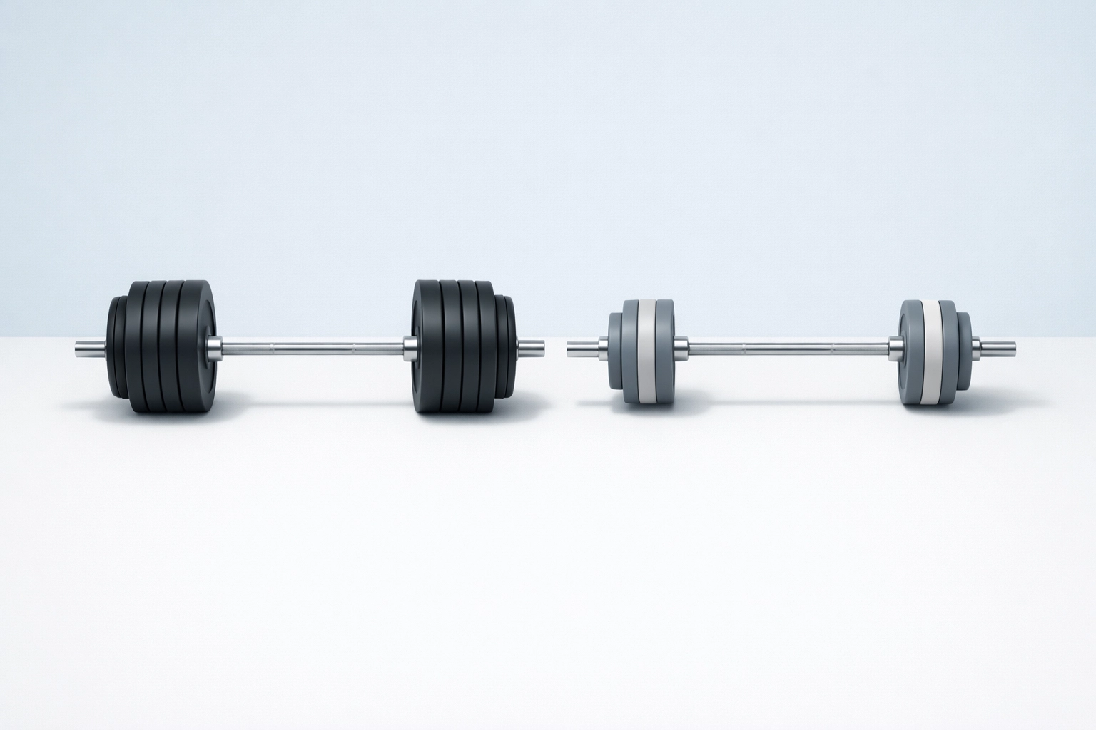 Heavy versus light barbell comparison demonstrating different weight training load options