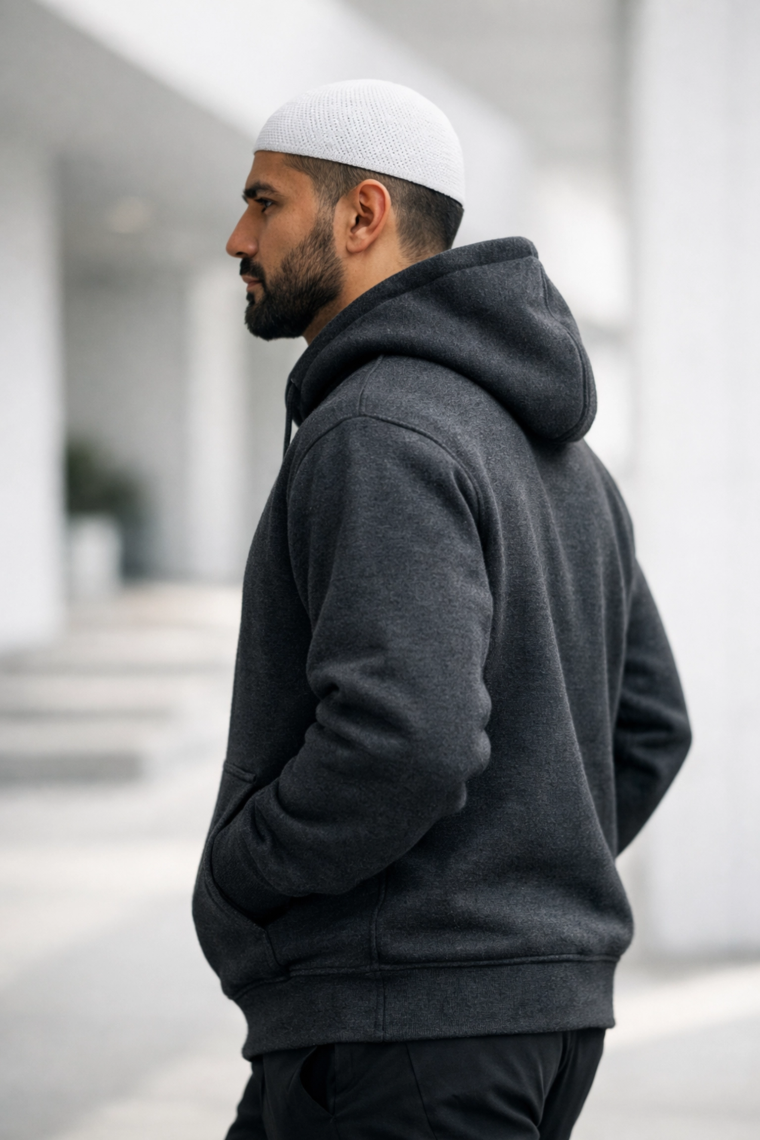 A man wearing a charcoal Sunnah Designs hoodie, showcasing modern subtle dawah and faith-based fashion.