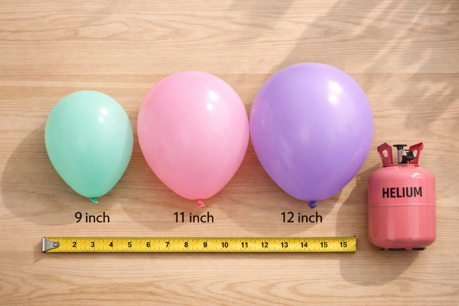 Different sized balloons next to helium canister showing size comparison