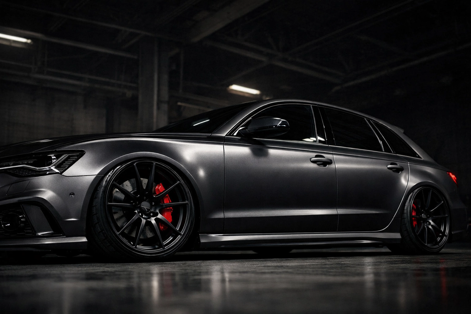 Lowered Audi RS6 in a workshop showing the impact of suspension modifications on ADAS sensor alignment.