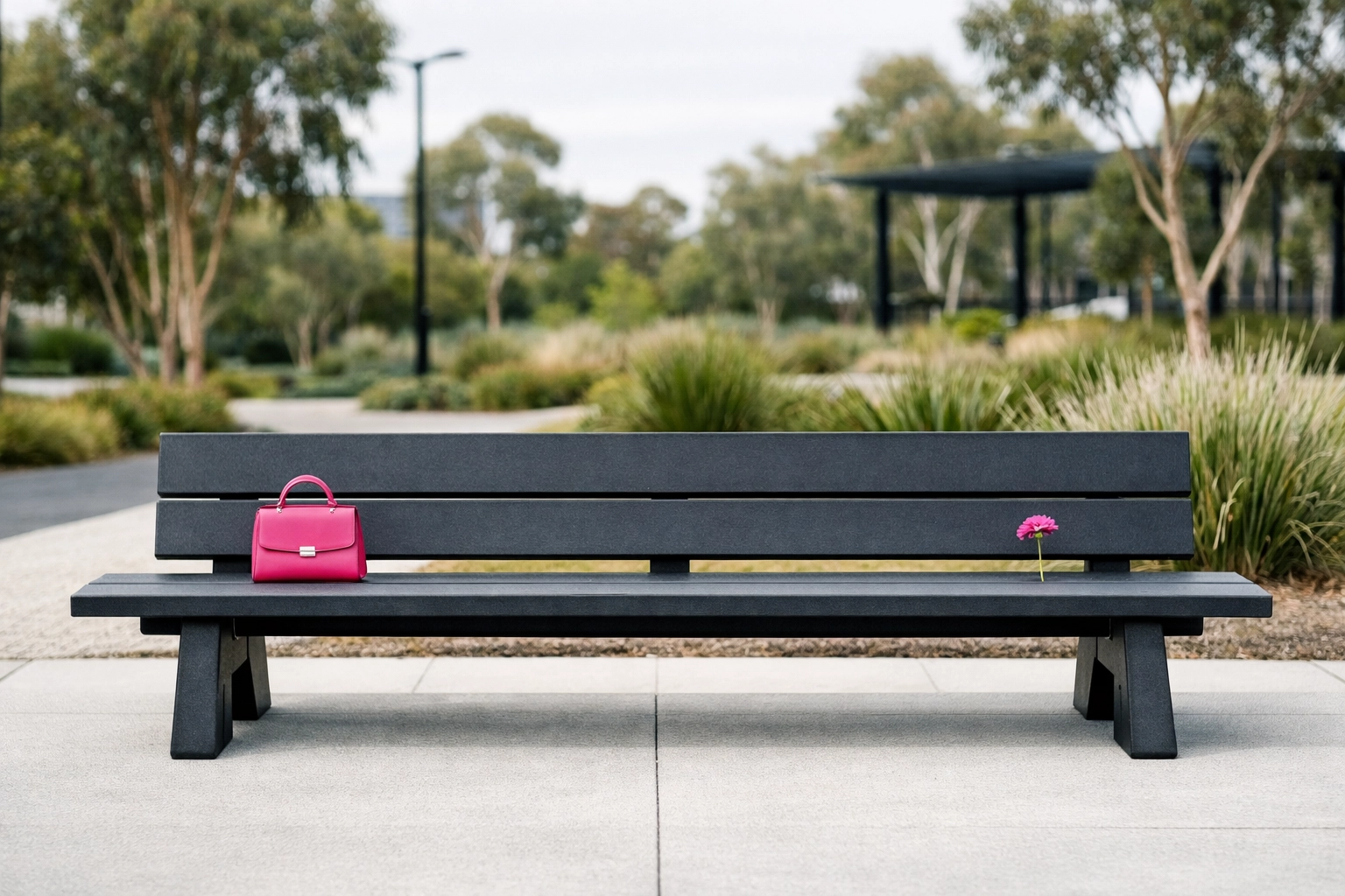 A modern public park bench made from recycled plastic panels highlighting sustainable infrastructure for local councils.