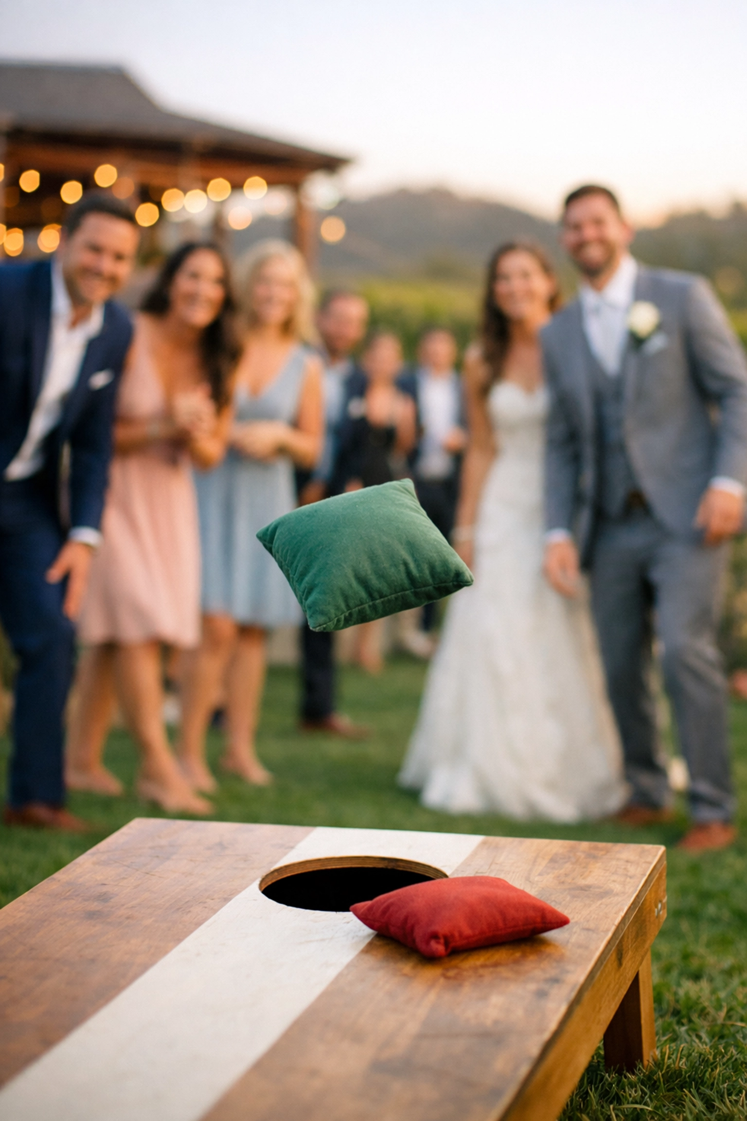 Cornhole bean bag toss game in action at an outdoor wedding in the Western Cape