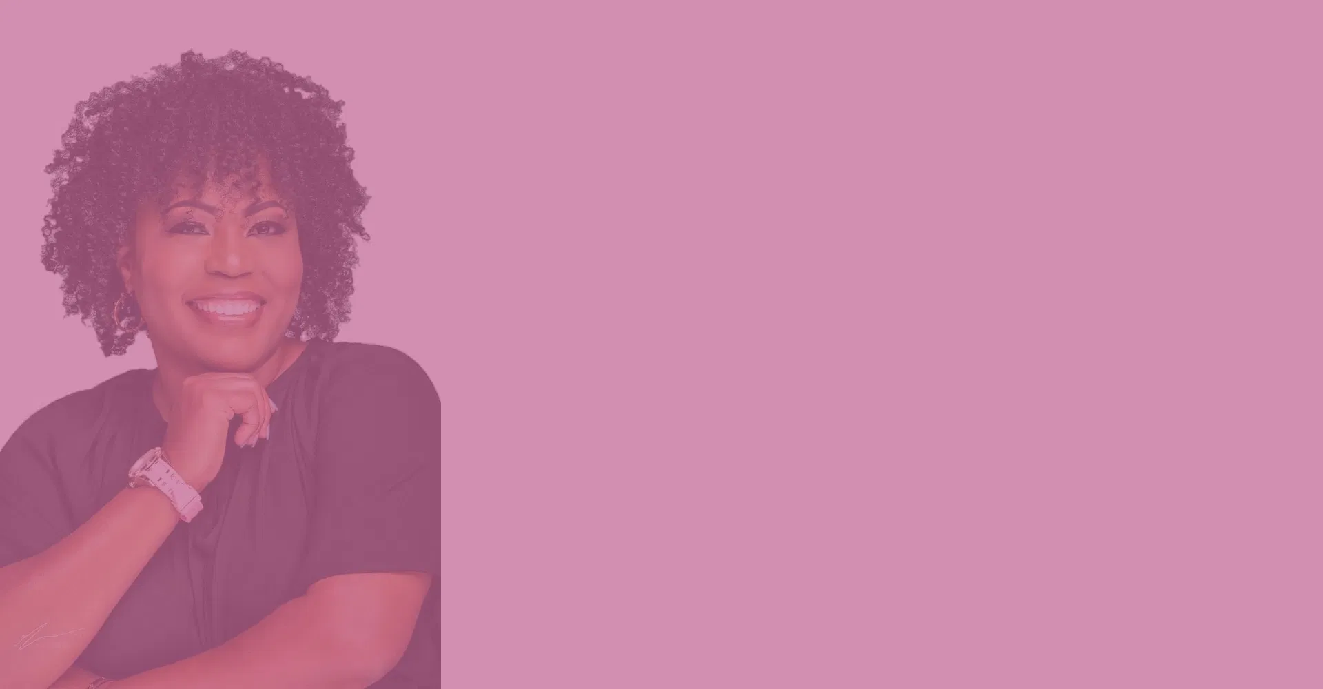 Monique Je' smiling and posing with hand on chin