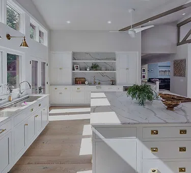 Modern chef's kitchen with white cabinetry and marble countertops showcasing Brentwood new construction trends