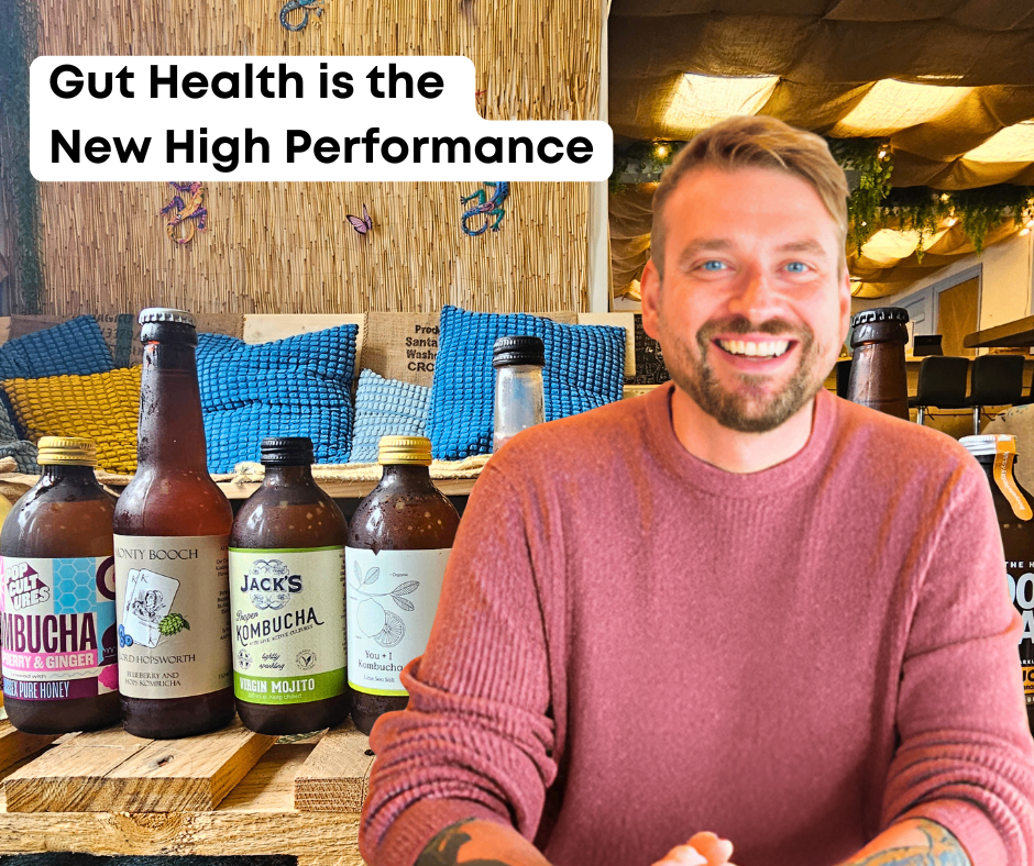 Range of kombucha on a wooden pallet with a man sat in front of them