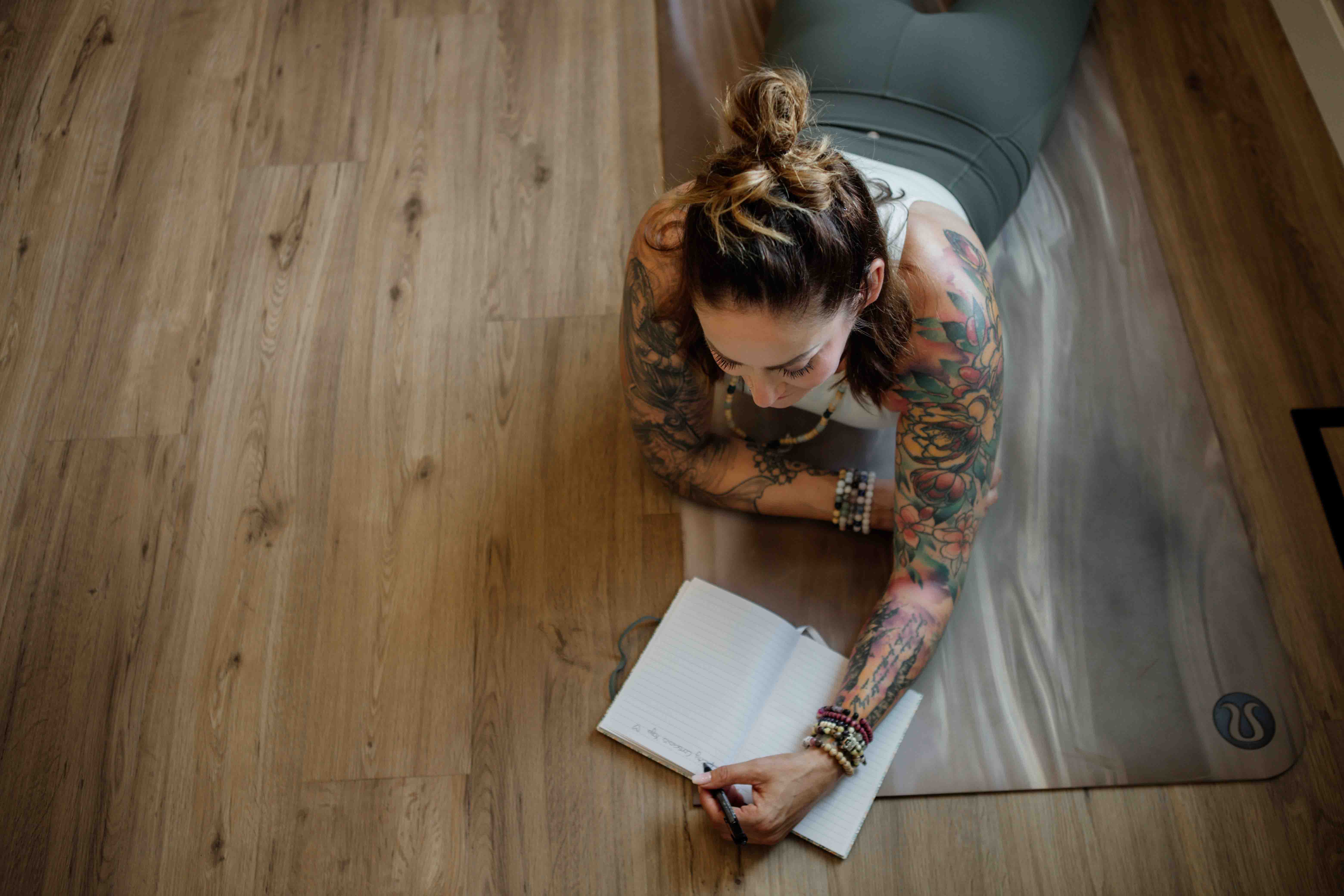 Midlife Woman Journaling on Yoga Mat