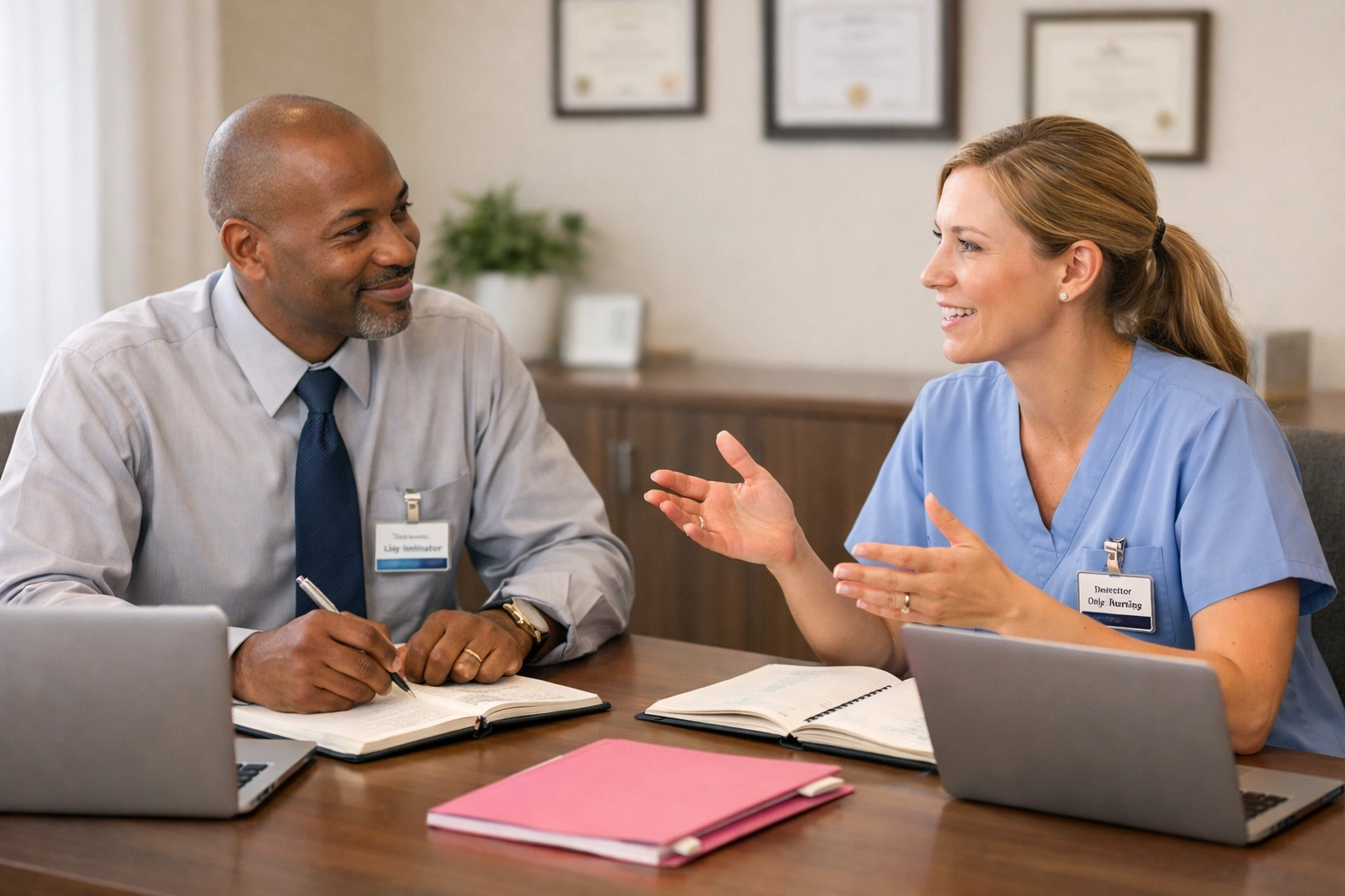 Administrator providing supportive one-on-one meeting with new Director of Nursing