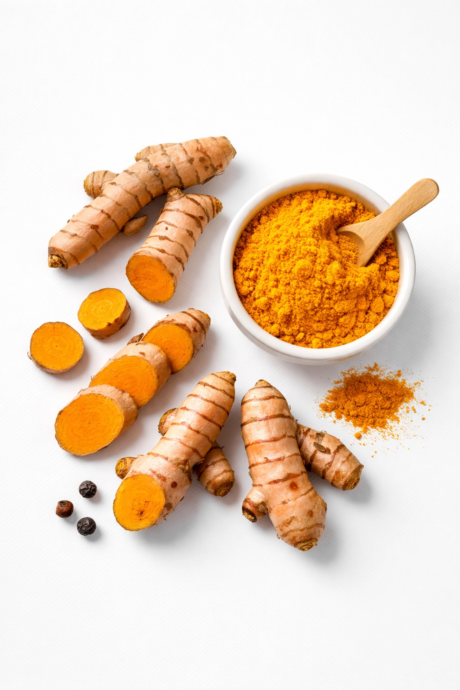 Fresh turmeric roots and turmeric powder with black pepper highlight natural anti-inflammatory foods