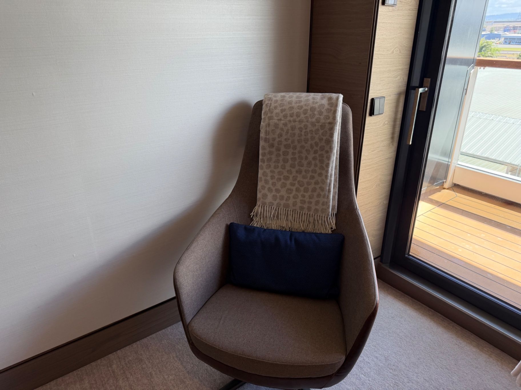 a chair with a blanket and pillow