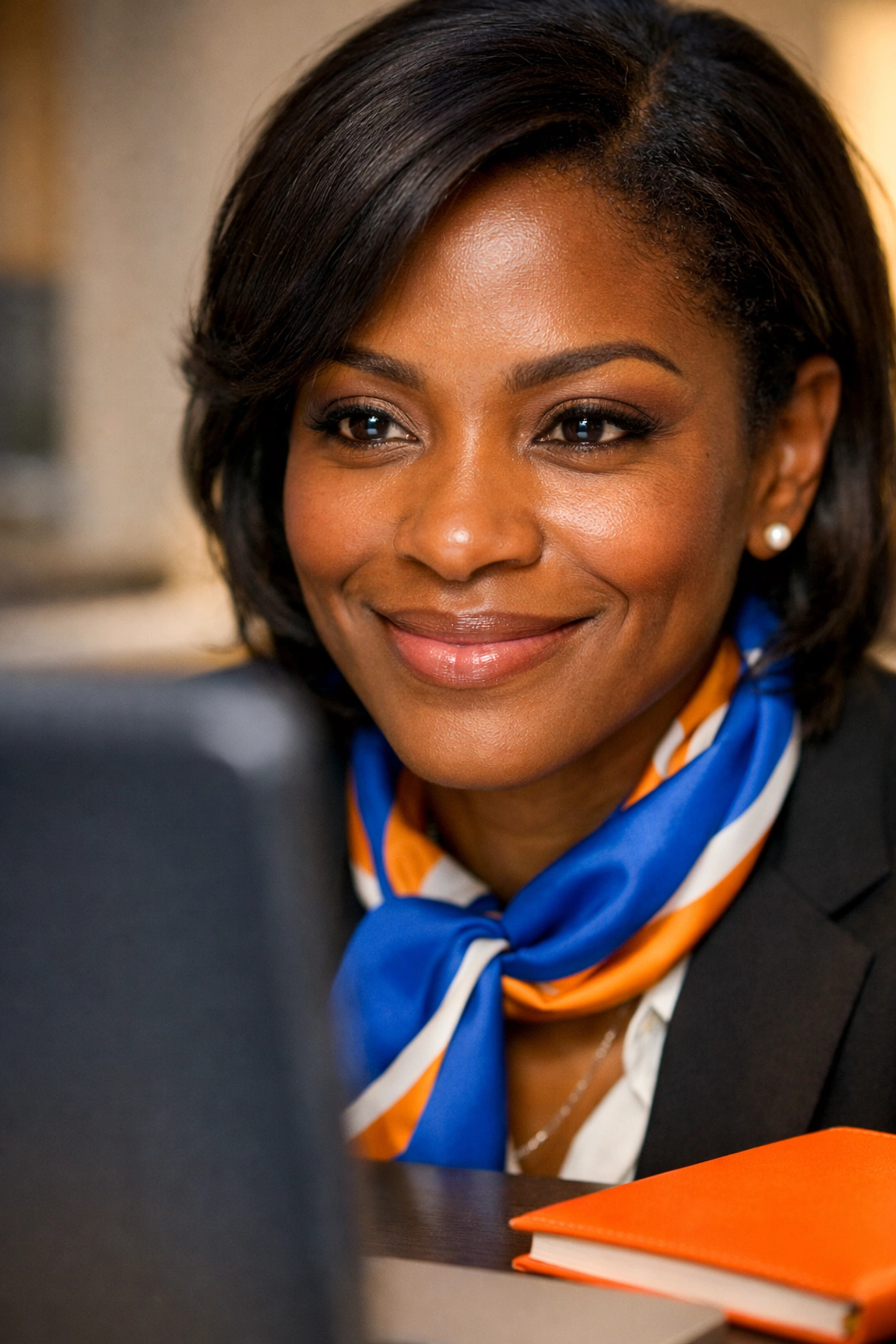 Professional Black woman leader smiling with clarity while reviewing an organized project plan on a computer screen.