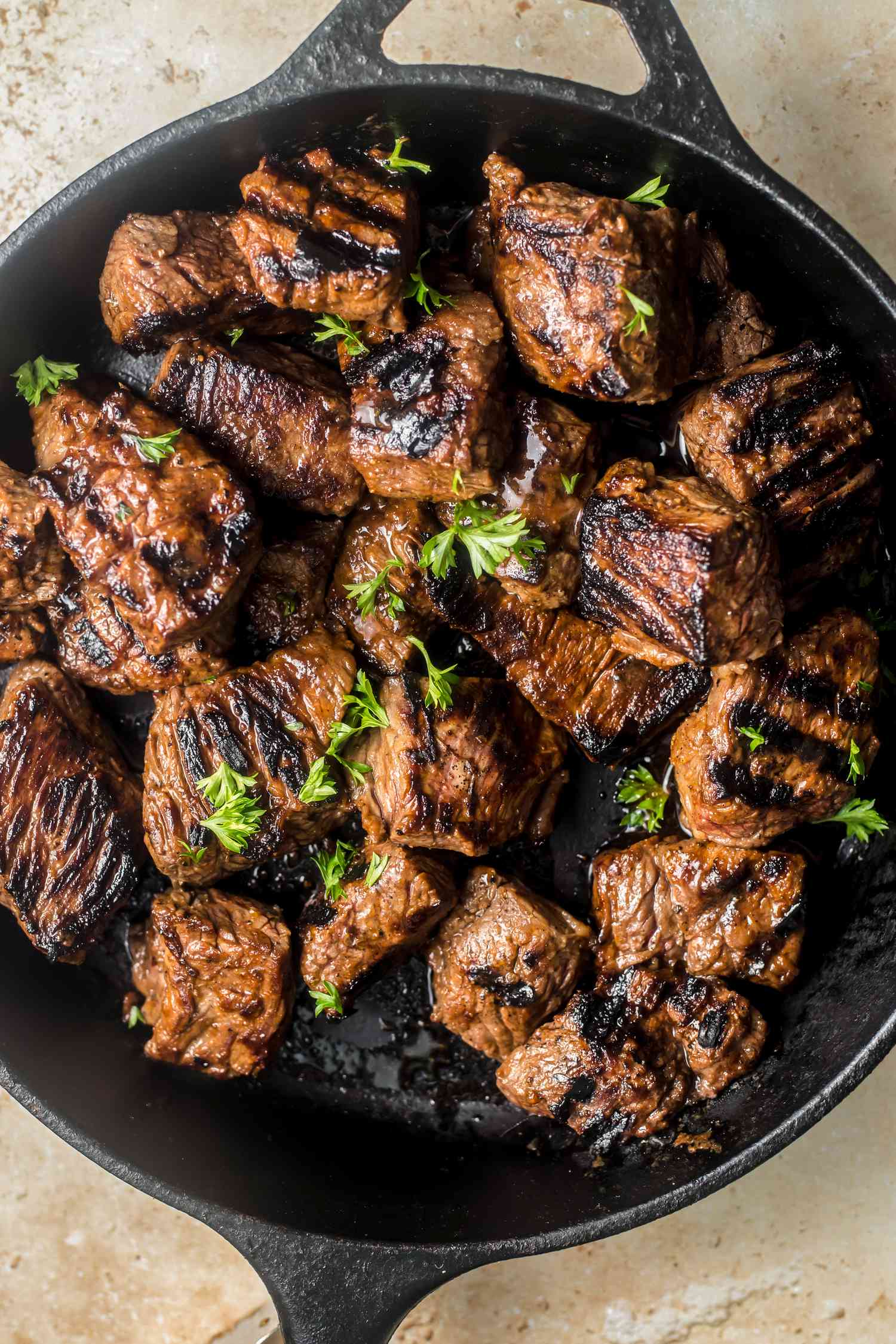 Marinated sirloin strips pan-searing in a cast iron skillet, showcasing quick farmhouse cooking