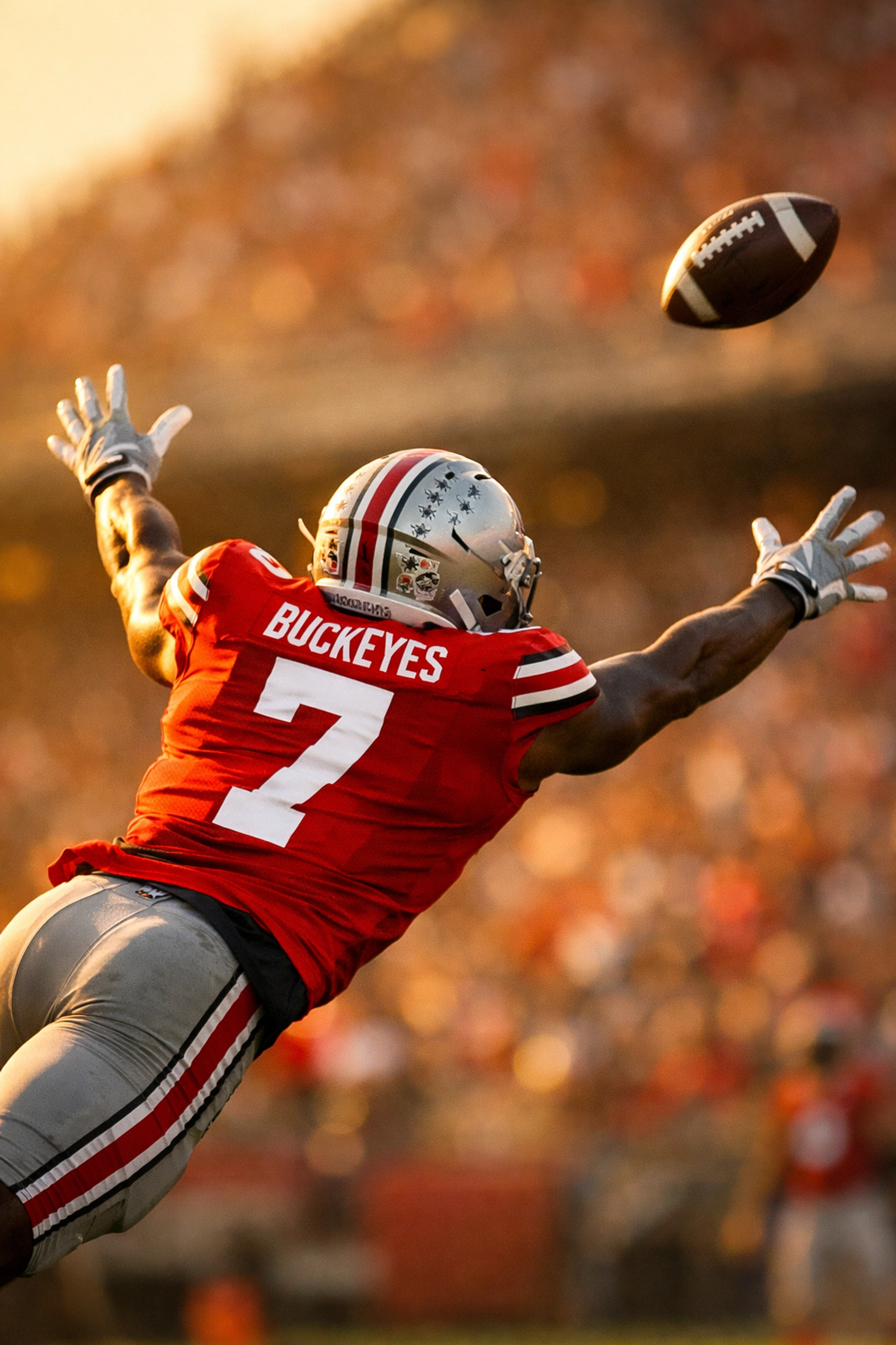 Ohio State cornerback extending wingspan to close on football in mid-air coverage