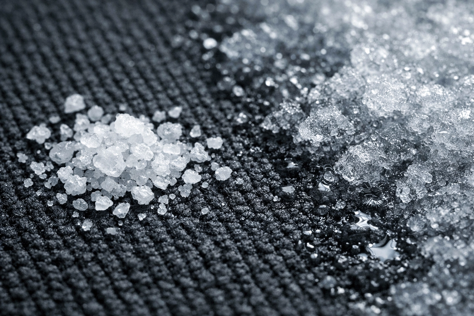 Close-up of winter salt crystals and slush on industrial carpet, damaging Midwest property flooring.